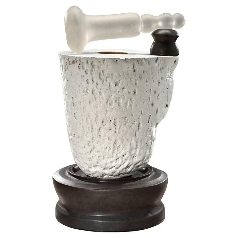 Contemporary American ceramic artist Richard Hirsch's Mortar and Glass Pestle Sculpture #4 was assembled in 2020. It's wheel thrown and hand built clay, gold enamel paint, black and white glazes with hot blown glass. Two separate pieces of stoneware