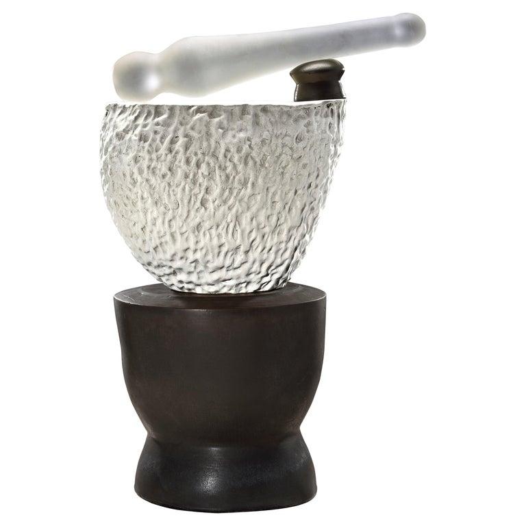 Contemporary American ceramic artist Richard Hirsch's Mortar and Glass Pestle Sculpture #5 was assembled in 2020. It's wheel thrown and hand built clay, gold enamel paint, black and white glazes with hot blown glass. Two separate pieces of stoneware