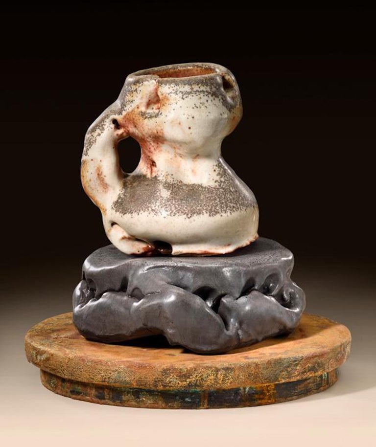 Contemporary American ceramic artist Richard Hirsch's Scholar Rock Cup Sculpture #16 was assembled in 2016. It's wheel thrown and hand built clay, wood fired stoneware with shino glaze, low fired black glaze and raku rust patinas. Hirsch creates