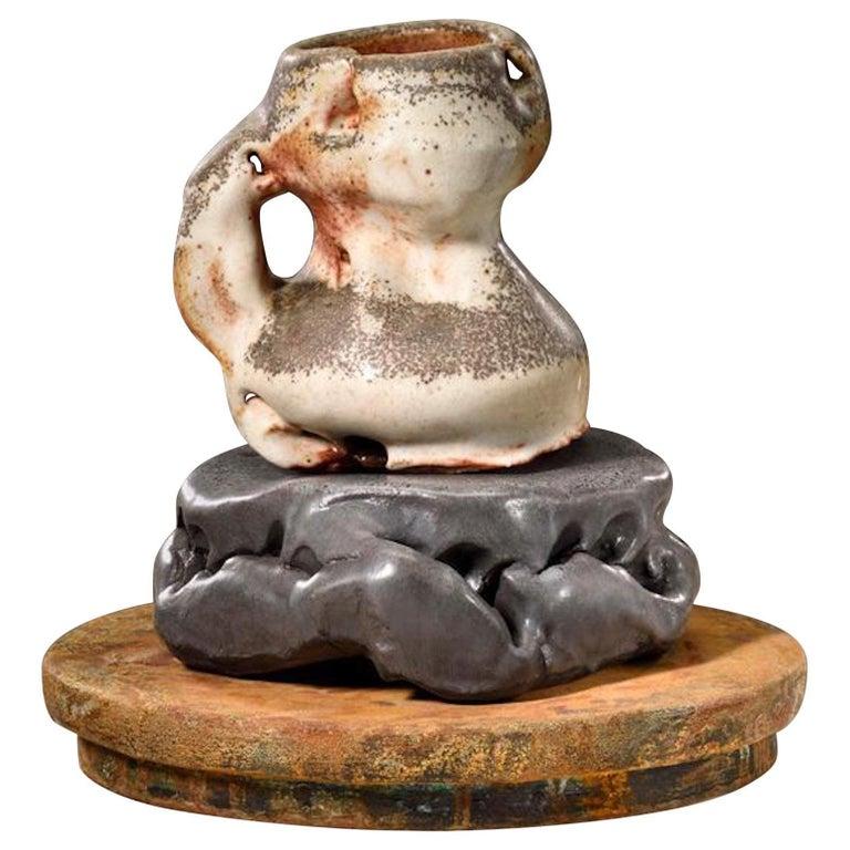 Contemporary American ceramic artist Richard Hirsch's Scholar Rock Cup Sculpture #16 was assembled in 2016. It's wheel thrown and hand built clay, wood fired stoneware with shino glaze, low fired black glaze and raku rust patinas. Hirsch creates