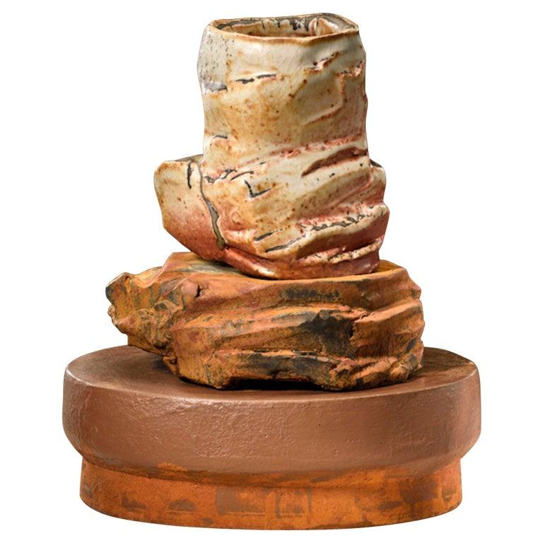 Contemporary American ceramic artist Richard Hirsch's Scholar Rock Cup Sculpture #19 was assembled in 2016. It's wheel thrown and hand built clay, wood fired stoneware with shino glaze, polychrome enamel paint over black glaze and low base red