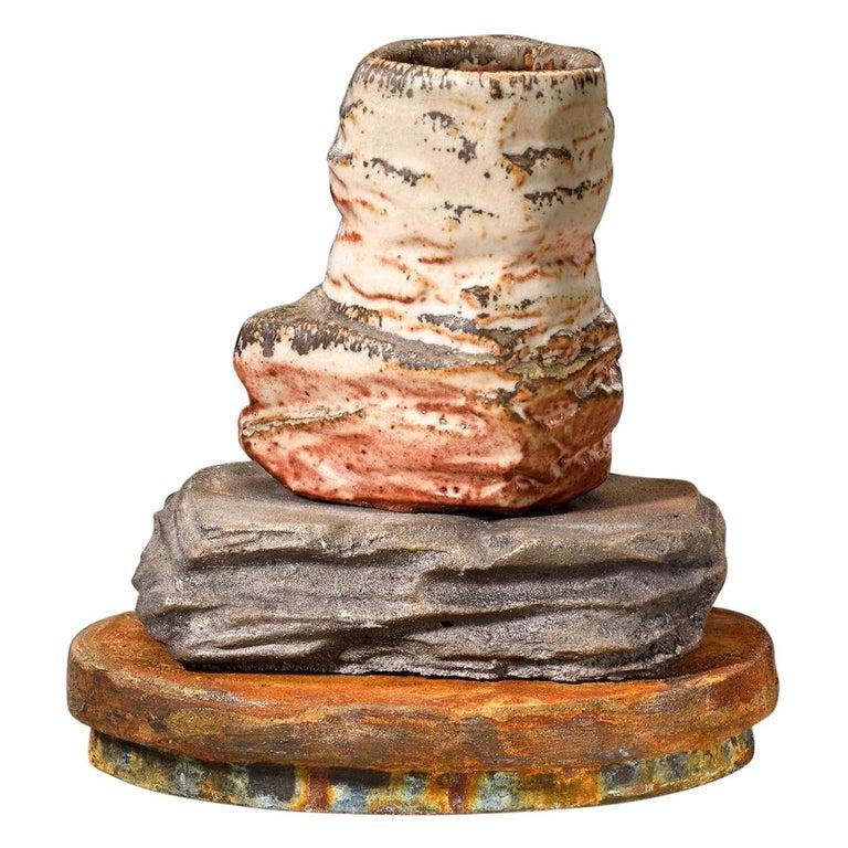 Contemporary American ceramic artist Richard Hirsch's Scholar Rock Cup Sculpture #20 was assembled in 2014. It's wheel thrown and hand built clay, low fire slips and shino glaze, raku rust patinas with a cast iron middle base. Hirsch creates ceramic