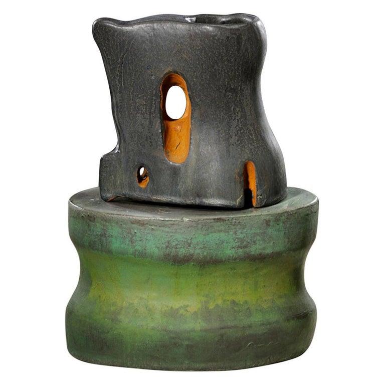 Contemporary American ceramic artist Richard Hirsch's scholar rock cup sculpture was assembled in 2011. It's wheel thrown and hand built clay with black glaze, raku rust patina, green and blue enamel polychrome paint. Hirsch creates ceramic