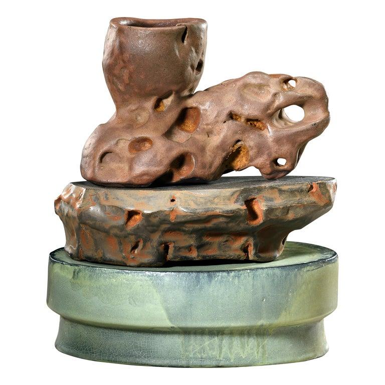 Contemporary American ceramic artist Richard Hirsch's Scholar Rock Cup Sculpture was assembled in 2018. It's wheel thrown and hand built clay with red and black glaze, raku rust patinas and polychrome enamel paint. Hirsch creates ceramic sculptures