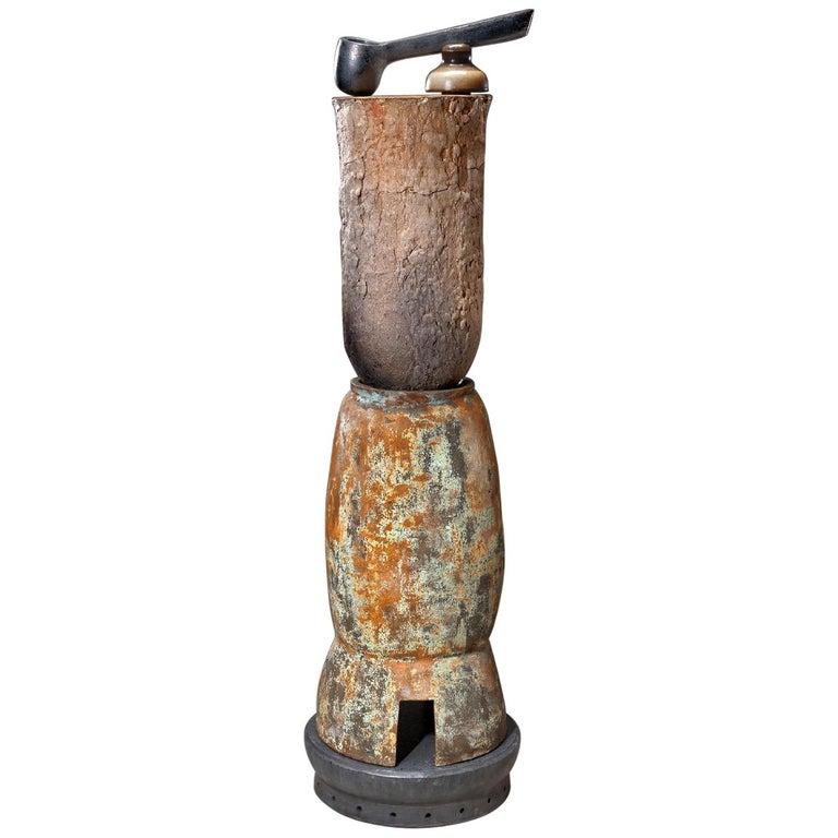 Contemporary American ceramic artist Richard Hirsch Ceramic Crucible Sculpture #12 was made in 2010. It's wheel thrown and hand built, wood fired with raku patinas and black glaze and has a found object (old ceramic insulator). In the book 