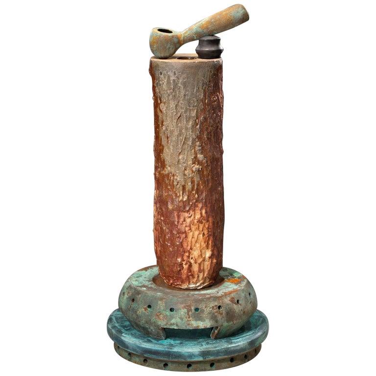 Contemporary American ceramic artist Richard Hirsch Ceramic Crucible Sculpture was made in 2018. It's wheel thrown and hand built clay, wood fired with bronze glaze and raku patinas. In the book 
