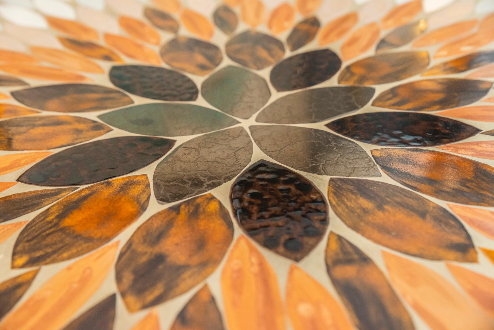 Richard Hohenberg, round coffee table, 
Teak and the center of the tray decorated with enameled ceramic marquetry in the form of polychrome leaves,
Signed with the stamp on the underside,
circa 1950, USA. 

Measures: Diameter 103 cm, height 40
