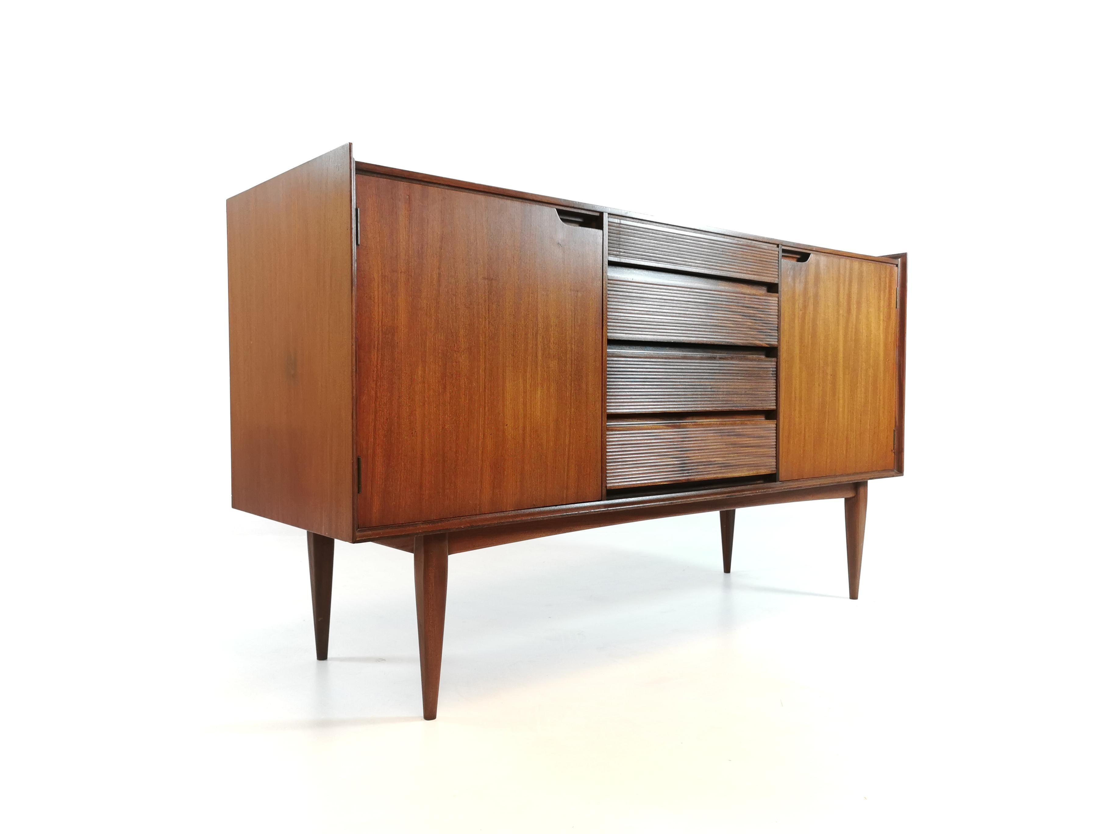 This sideboard was designed by Richard Hornby for Fyne Ladye Furniture Ltd. Made in the United Kingdom during the 1960s. 

The sideboard features four drawers and two shelved cupboard storage spaces.

Made with Afromosia.