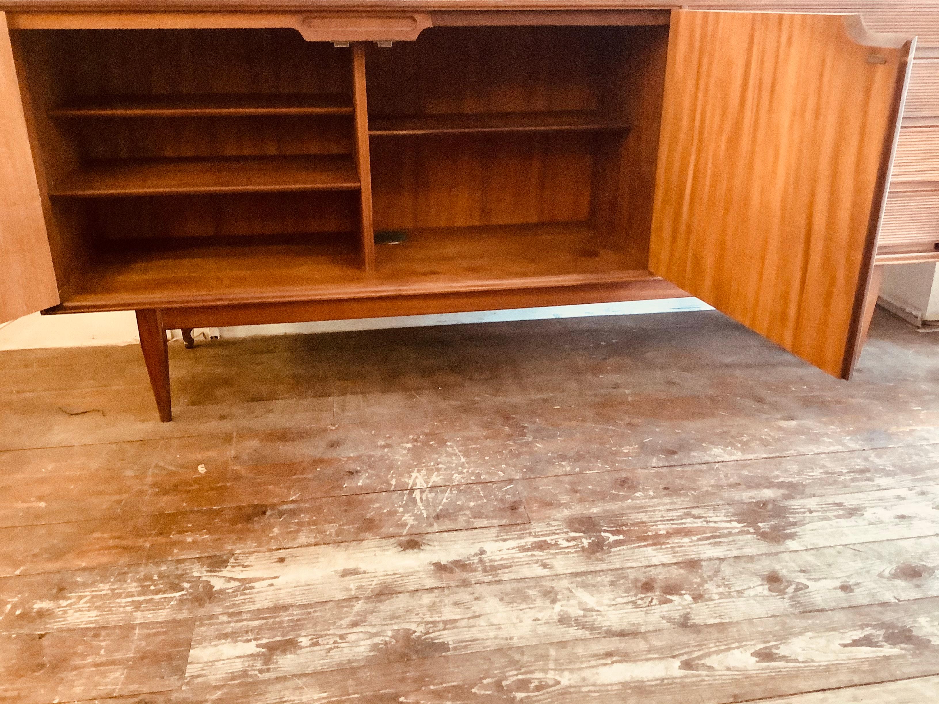1960’s teak and Afrormosia sideboard designed by Richard Hornby for Heal’s. An impressive sideboard with stunning Afrormosia teak grain and pattern and mid-century styling including the ridged drawer fronts with dovetail joints, internal shelving