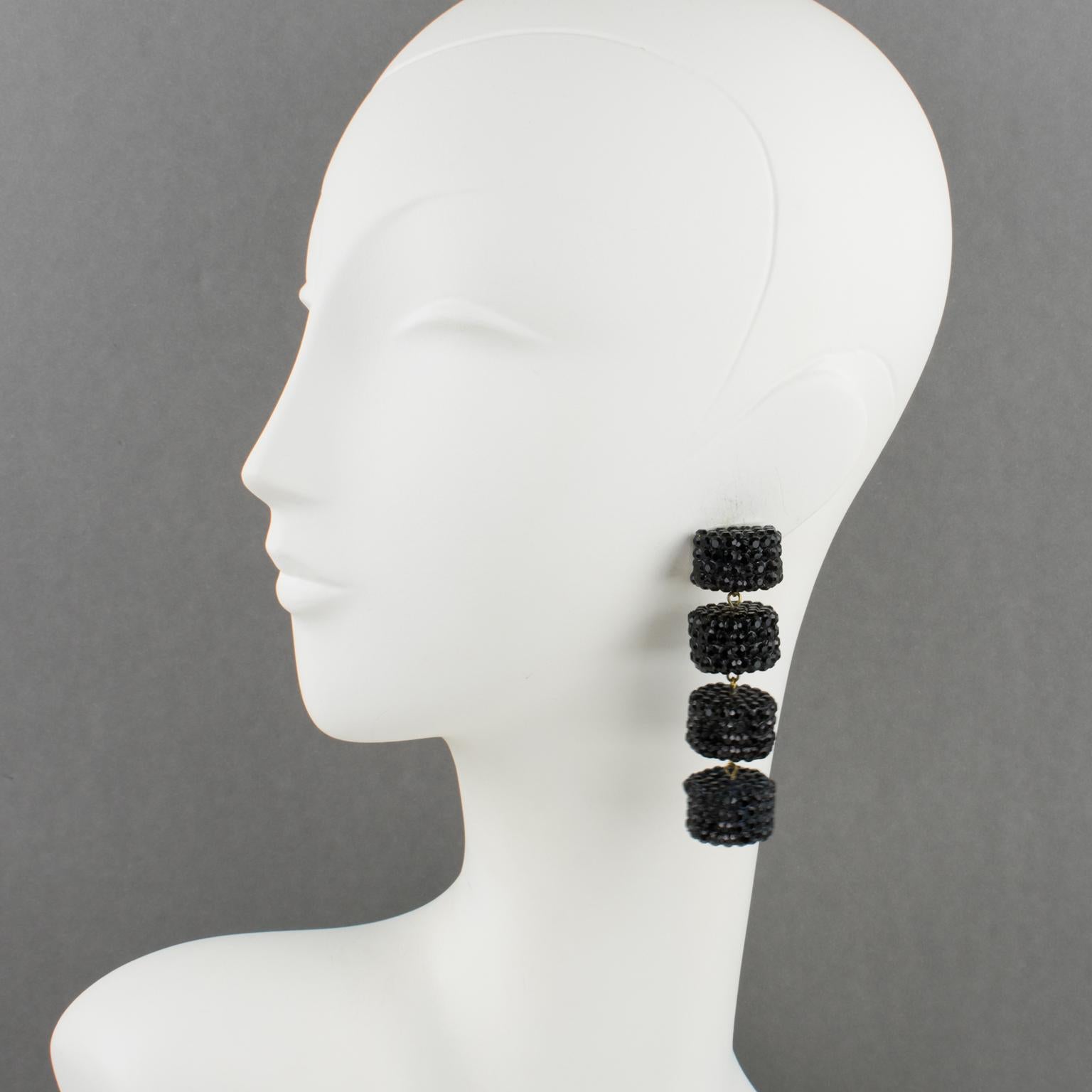These stunning statement clip-on earrings, designed by Richard Kerr in the 1980s, are made-up of his signature pave rhinestones. 
The clips feature an oversized geometric design with dangling elements, all covered with licorice black crystal