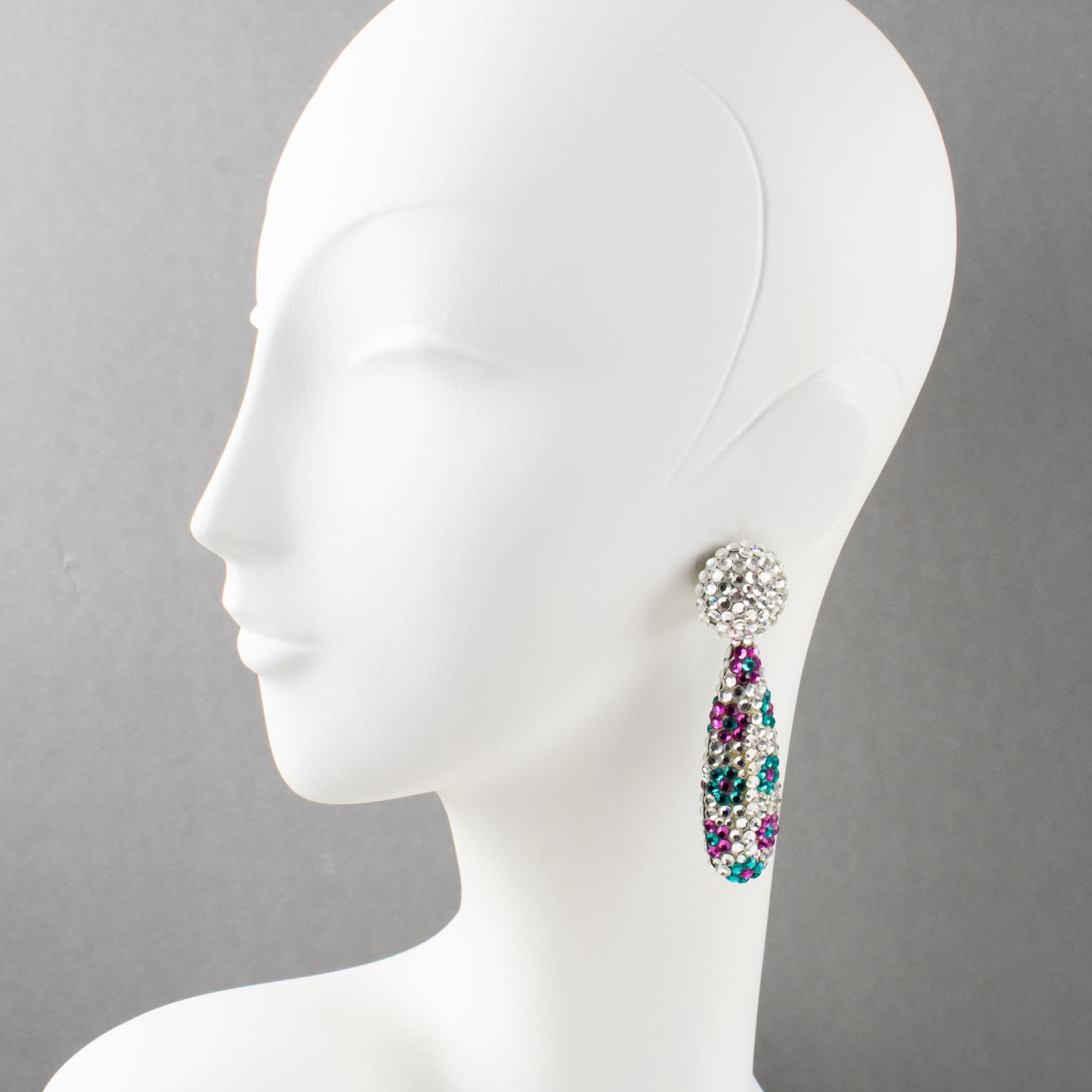 Richard Kerr designed these fabulous clip-on earrings in the 1980s. They are made up of his signature pave rhinestones. The set features a dangle geometric drop shape all covered with silver crystal rhinestones and complimented with a floral design