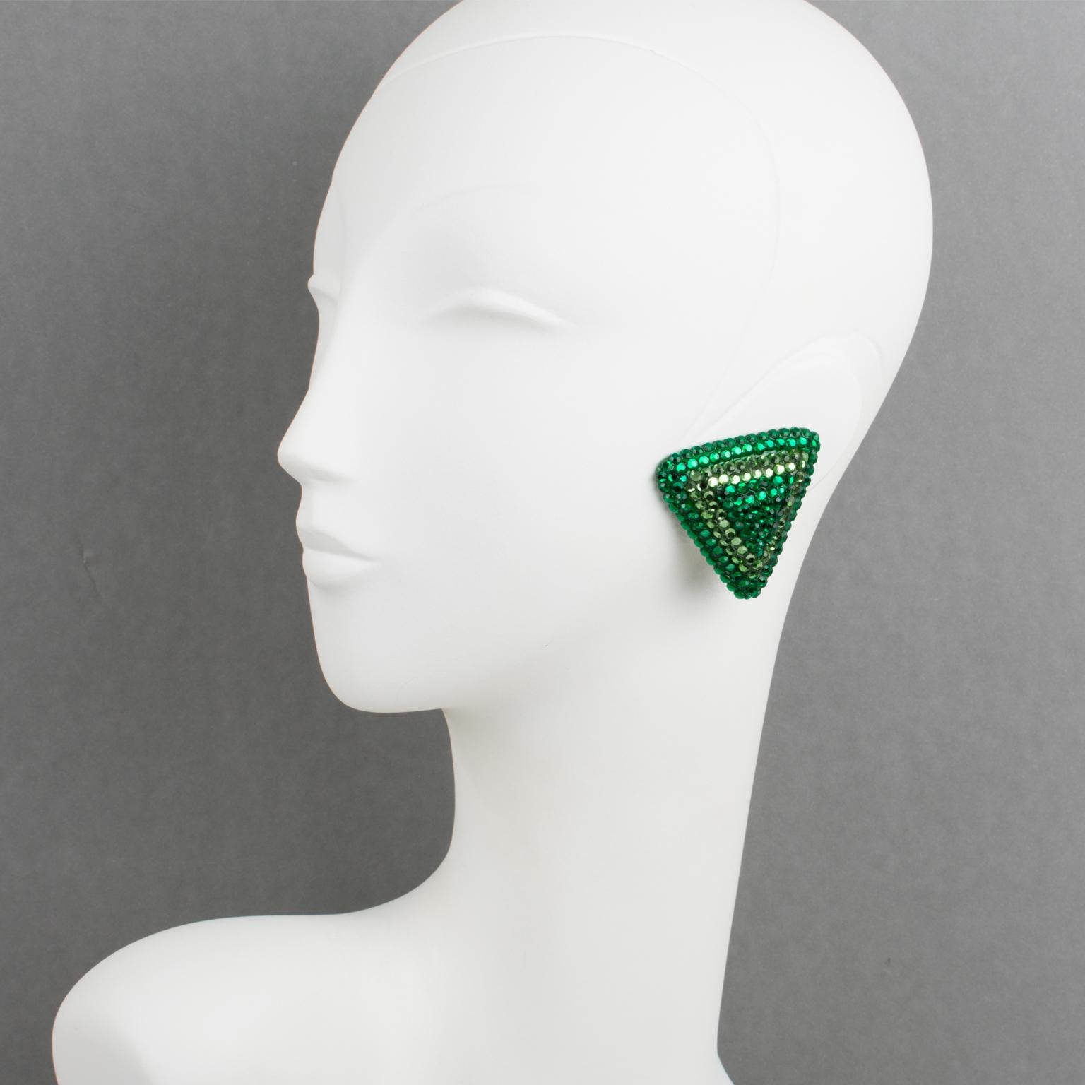 Richard Kerr created these lovely statement clip-on earrings in the 1980s. They are made up of his signature pave rhinestones. The earrings feature an oversized triangle shape, all covered with colorful crystal rhinestones on a green resin