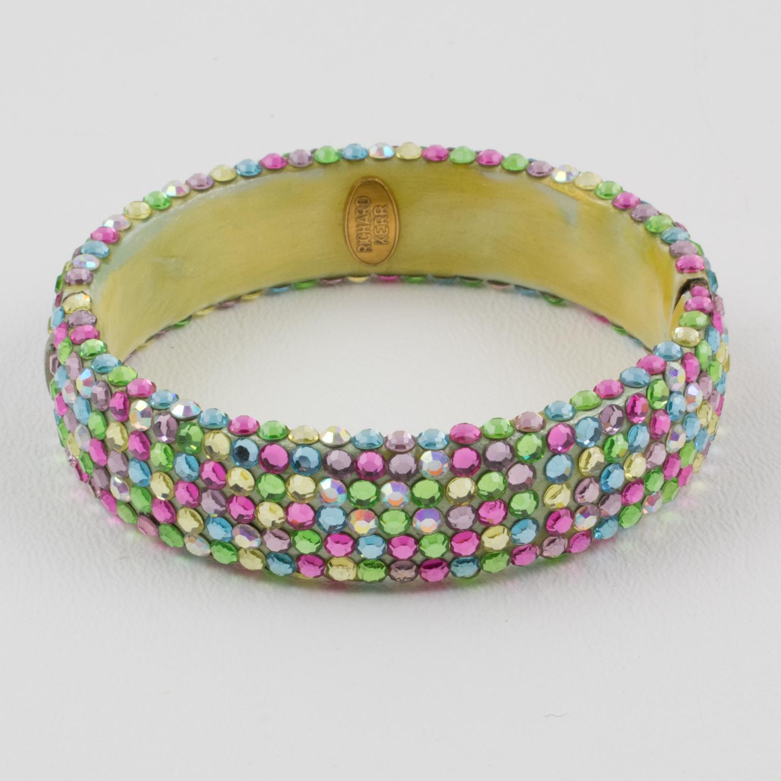 Fabulous statement clamper bracelet designed by Richard Kerr in the 1980s and made up of his signature pave rhinestones. The bracelet features a large band shape, all covered with multicolor crystal rhinestones. 
Assorted tutti frutti pastel colors