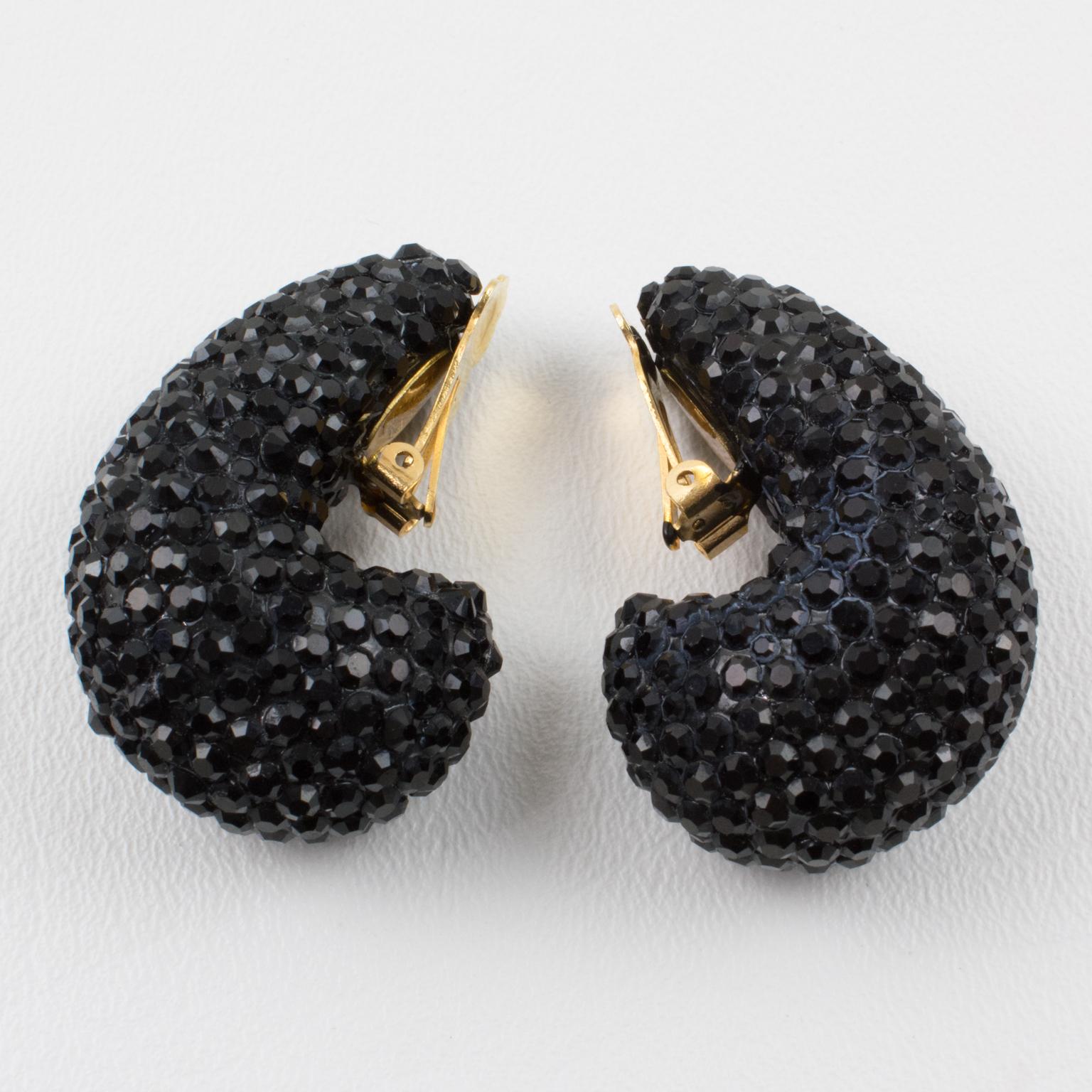 Impressive statement clip-on earrings designed by Richard Kerr in the 1980s. They are made up of his signature pave crystals. Featuring nautilus shape all covered with licorice black color rhinestones. Marked at the back with the designer tag