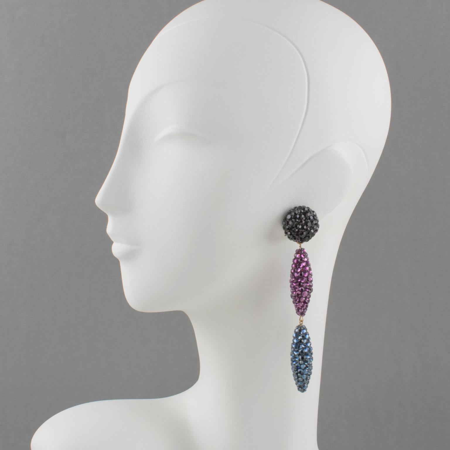 Sophisticated statement clip-on earrings designed by Richard Kerr in the 1980s. They are made up of his signature pave rhinestones. Featuring dangle extra-long drop shape all covered with crystal rhinestones. Assorted colors of licorice black,