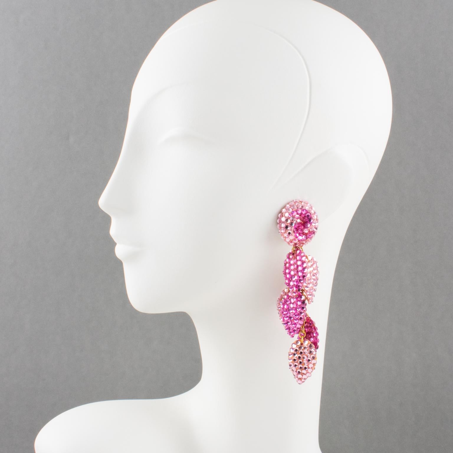 Stylish statement clip-on earrings designed by Richard Kerr in the 1980s. They are made up of his signature pave rhinestones. Featuring extra-long dangling shape with multi-chain and leaves shaped elements attached to them, all covered with colorful