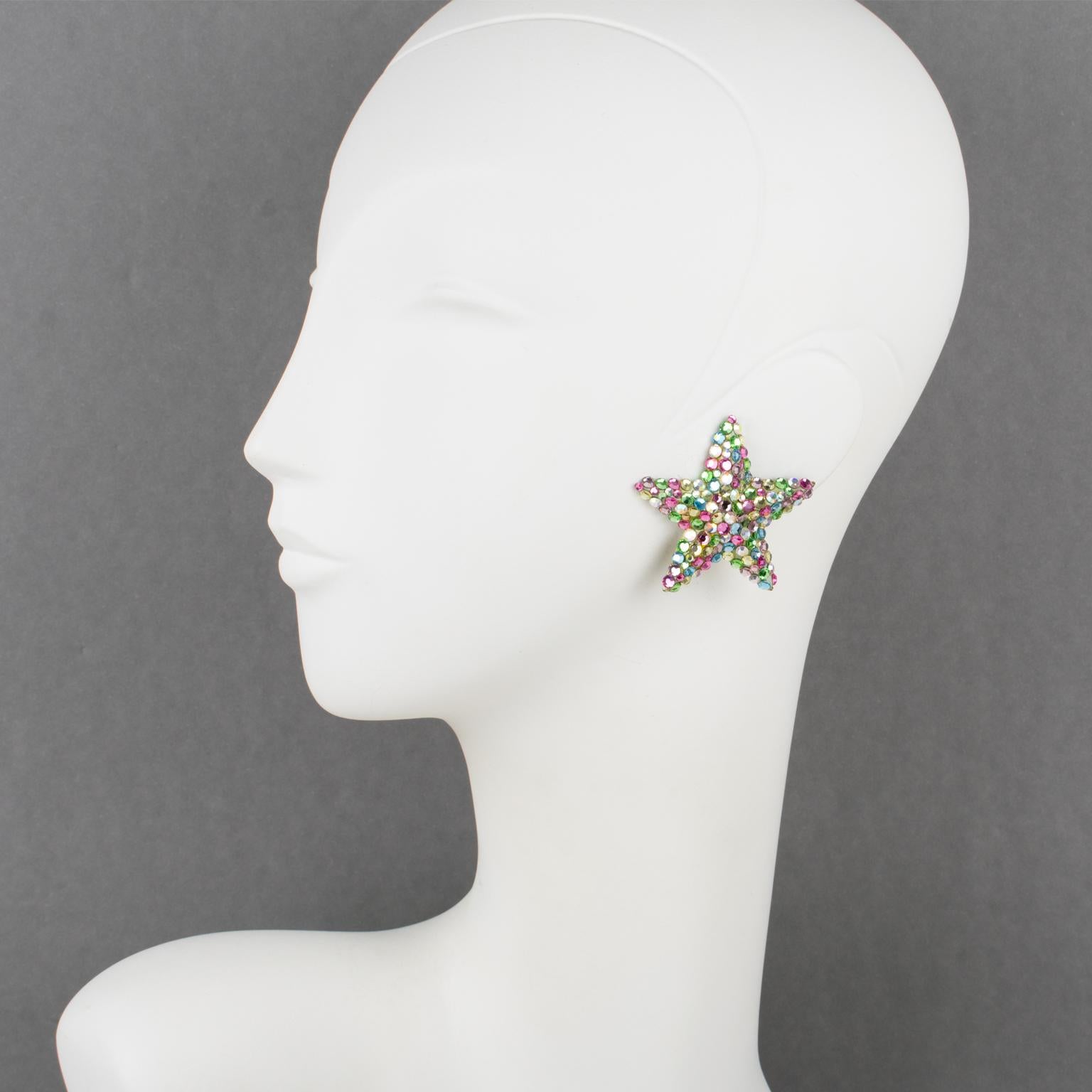 Lovely statement clip-on earrings designed by Richard Kerr in the 1980s. They are made of his signature pave rhinestones. 
They feature an oversized star shape covered with multicolor crystal rhinestones. A beige resin background frame. Assorted