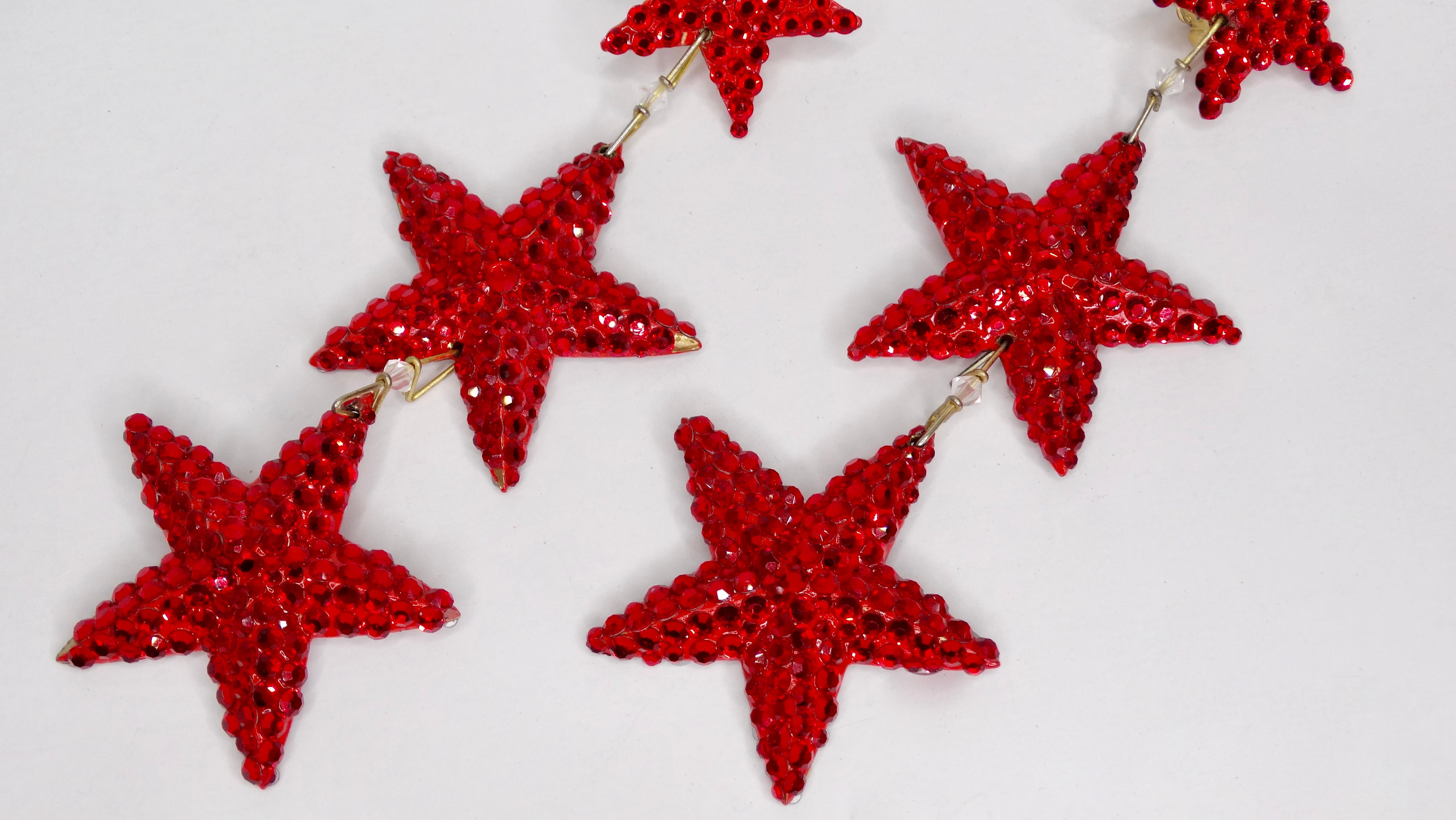 The most divine pair of Richard Kerr rhinestone earrings from the 1980s! Earrings feature three red rhinestone embellished stars with clip on backs. Stamped Richard Kerr drops down 4 inches. The perfect accent piece to any evening or daytime look! 