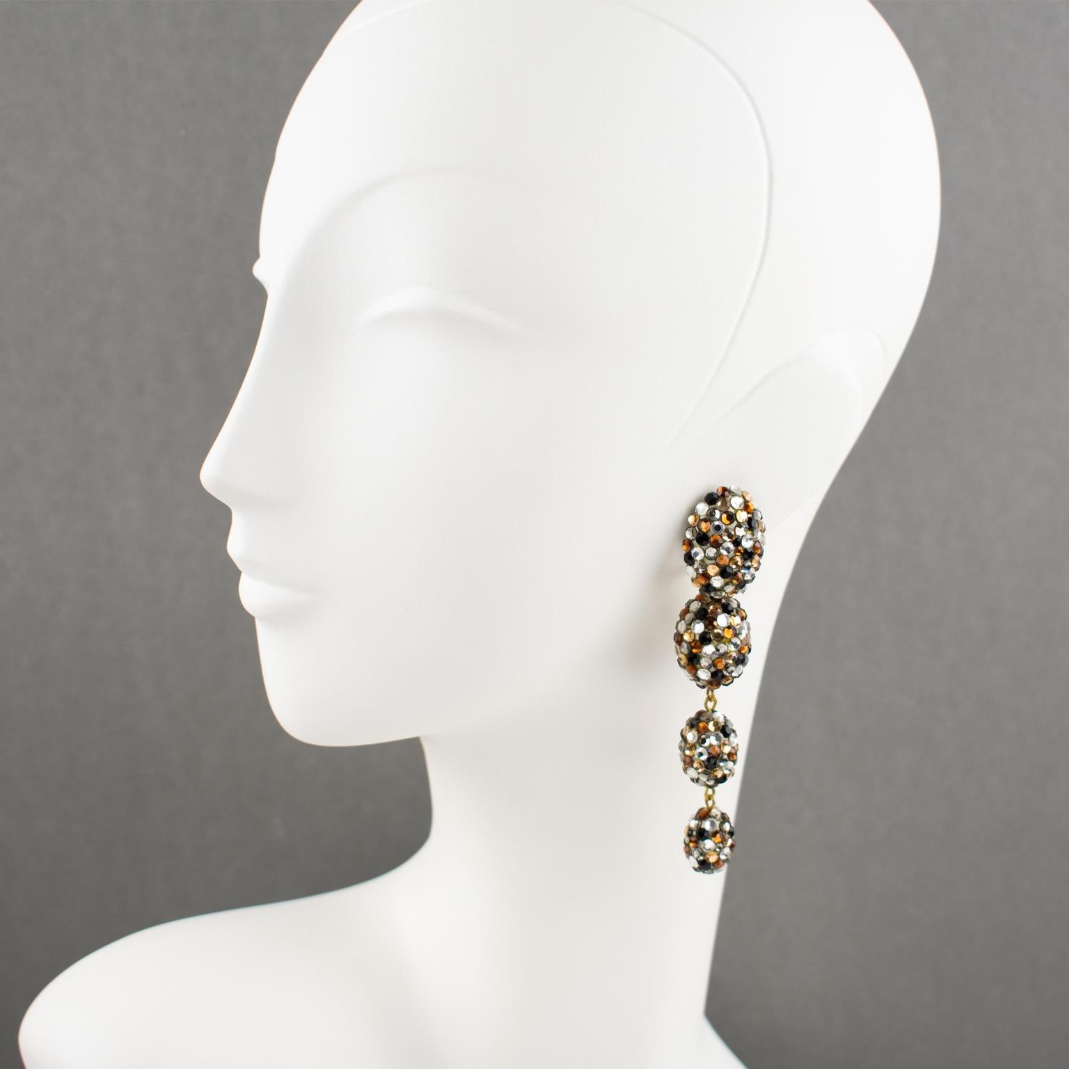 Richard Kerr designed these gorgeous statement clip-on earrings in the 1980s. They are made up of his signature pave rhinestones. The extra-long dangling design with graduated egg-shaped beads is all covered with crystal rhinestones on a beige resin