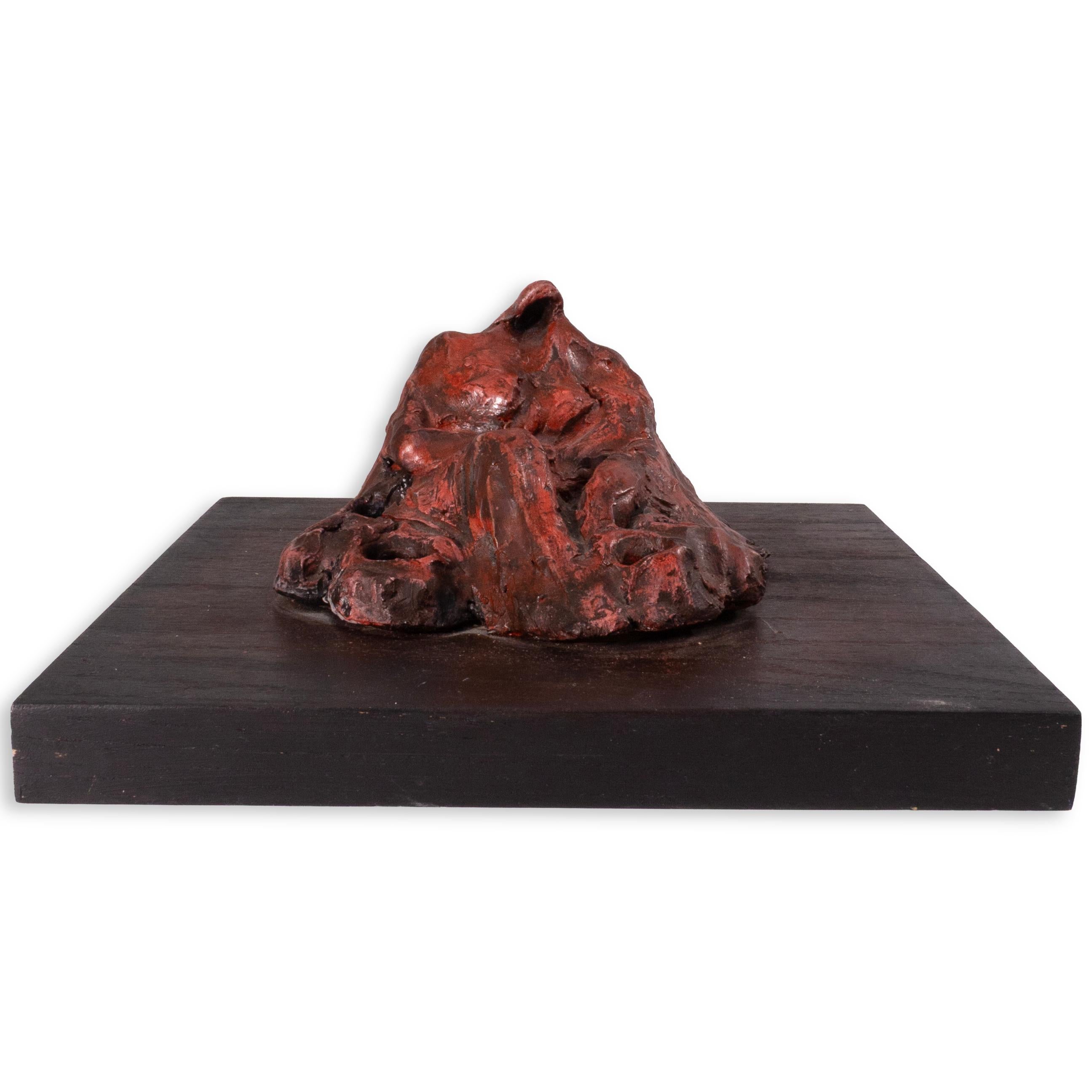 This untitled 1996 work by Richard Kozlow is a cast bronze sculpture finished in a rich red patina, mounted on a dark wood base. Its abstract, textured form blends organic irregularity with sculptural weight, evoking both natural formations and