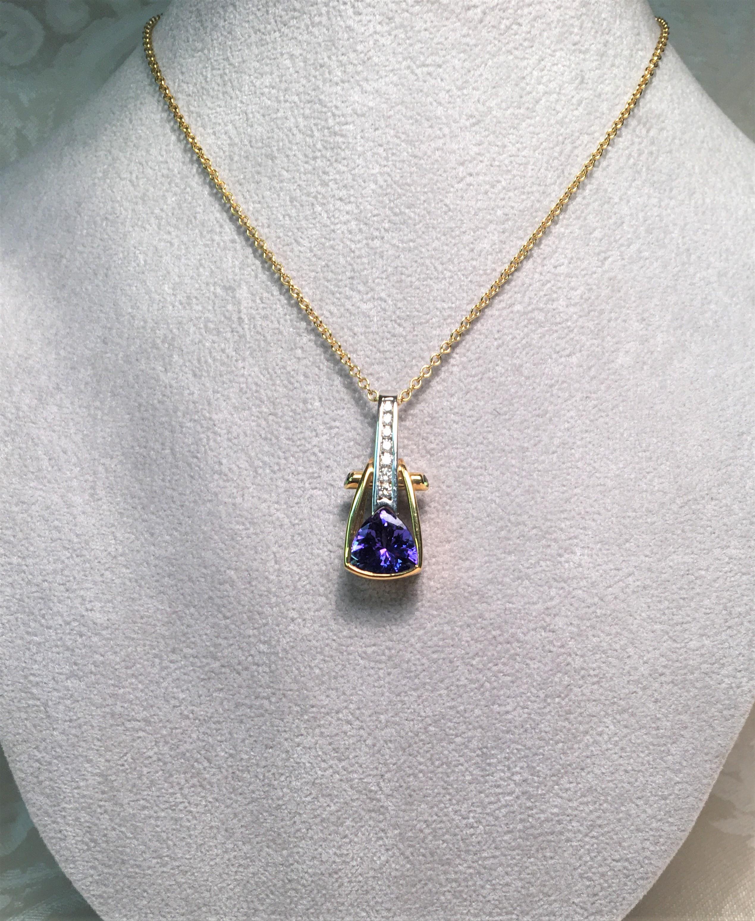This beautiful pendant by Richard Krementz Gemstones will complete any outfit!
2.12 carat trillion tanzanite, fine bluish-purple color
7 round cut diamonds approximately .14 total diamond weight, channel set
2 round green faceted tsavorite stones,