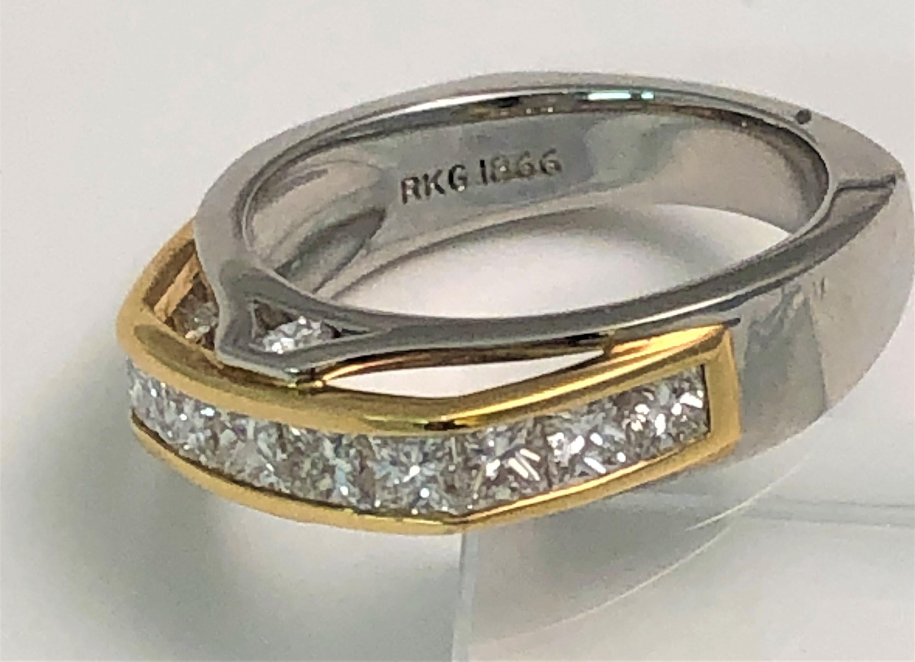 By designer Richard Krementz, this diamond ring is true to his design style!
18 karat yellow gold and platinum 'bridge' design.
Can be worn alone or stacked with other rings.
11 princess cut diamonds across top of ring, channel set.  Each