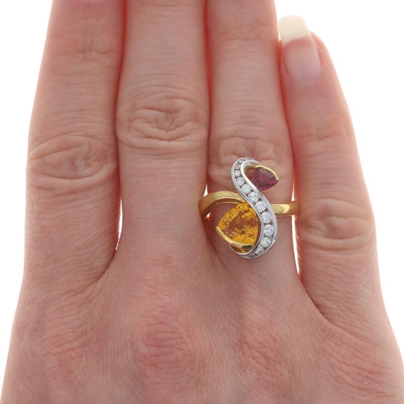 Size: 6 1/2
Please contact us for a resizing quote.

Brand: Richard Krementz

Metal Content: 18k Yellow Gold & Platinum

Stone Information
Natural Sapphires
Treatment: Heating
Carat(s): 2.30ctw
Cut: Trillion
Color: Orange & Pink

Natural