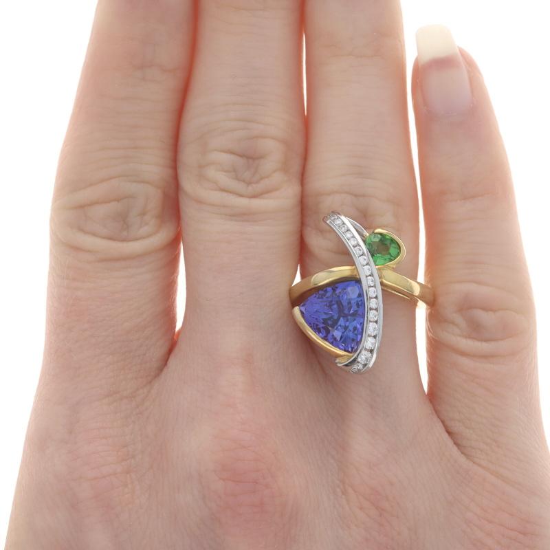 Size: 6 1/2
Please contact us for a resizing quote.

Brand: Richard Krementz

Metal Content: 18k Yellow Gold & Platinum

Stone Information
Natural Tanzanite
Treatment: Routinely Enhanced
Carat(s): 2.61ct
Cut: Trillion
Color: Purple

Natural