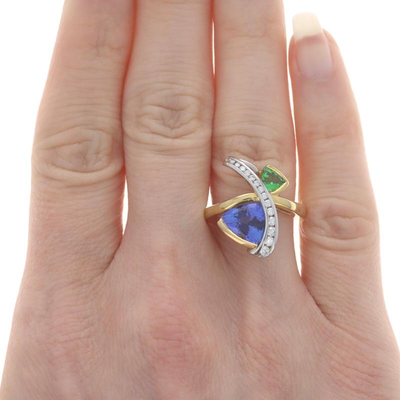Size: 6 1/4
Please contact us for a resizing quote.

Brand: Richard Krementz

Metal Content: 18k Yellow Gold & Platinum

Stone Information
Natural Tanzanite
Treatment: Routinely Enhanced
Carat(s): 3.68ct
Cut: Trillion
Color: Purple

Natural