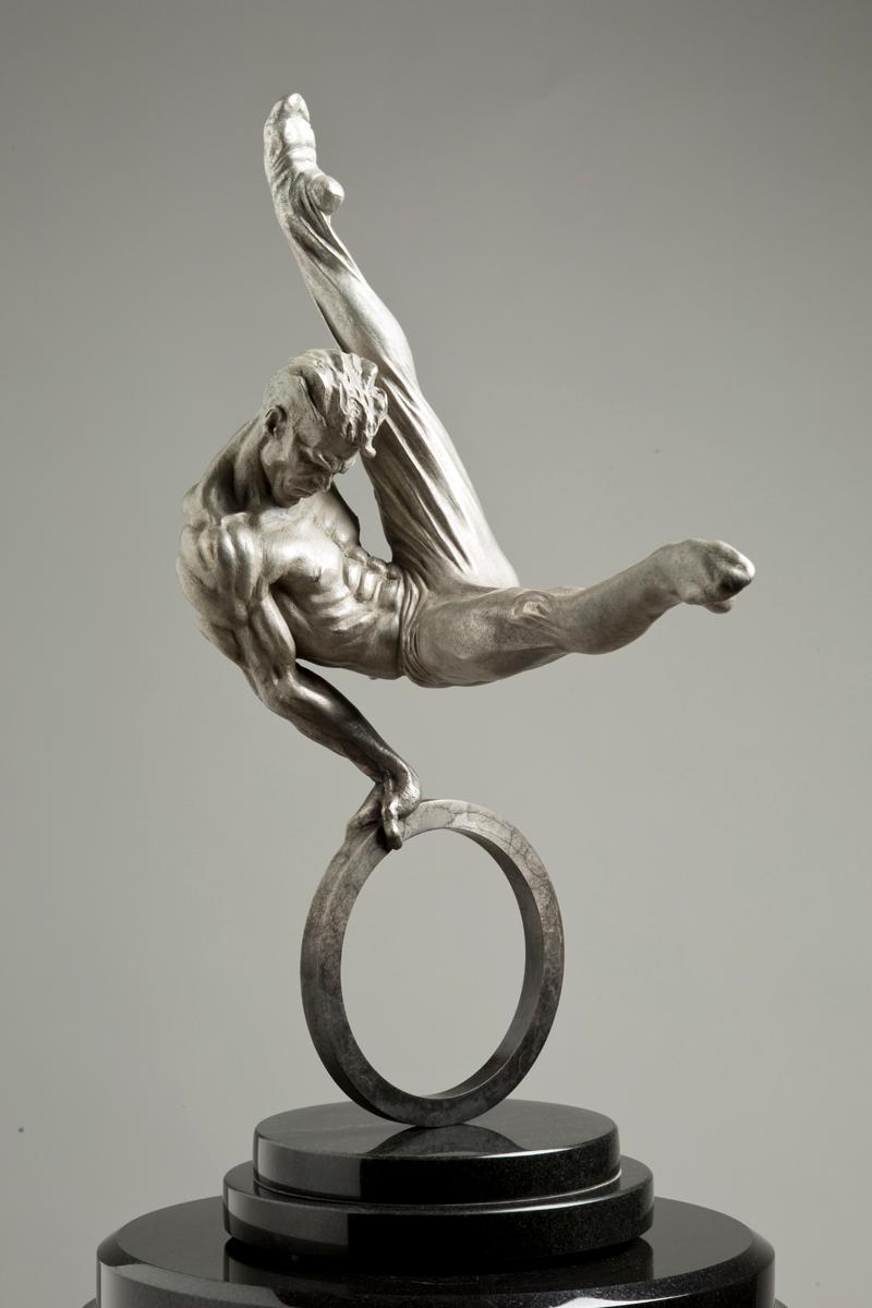 The Gymnast Eighth Life Platinum is part of the 20th Anniversary Commemorative Collection celebrating the monument titled Flair Across America , which was created by the artist Richard MacDonald for the 1996 Atlanta Summer Olympics. The Gymnast