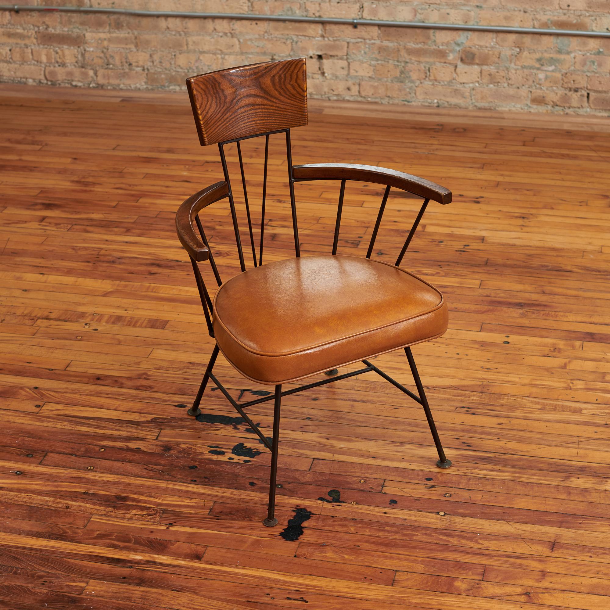 Beautiful set of 6 dining chairs designed by Richard McCarthy for Selrite. These Circa 1950s chairs consist of an iron frame with brown vegan leather cushion and wooden armrests. Chairs are in great condition with wear consistent with age and use.
