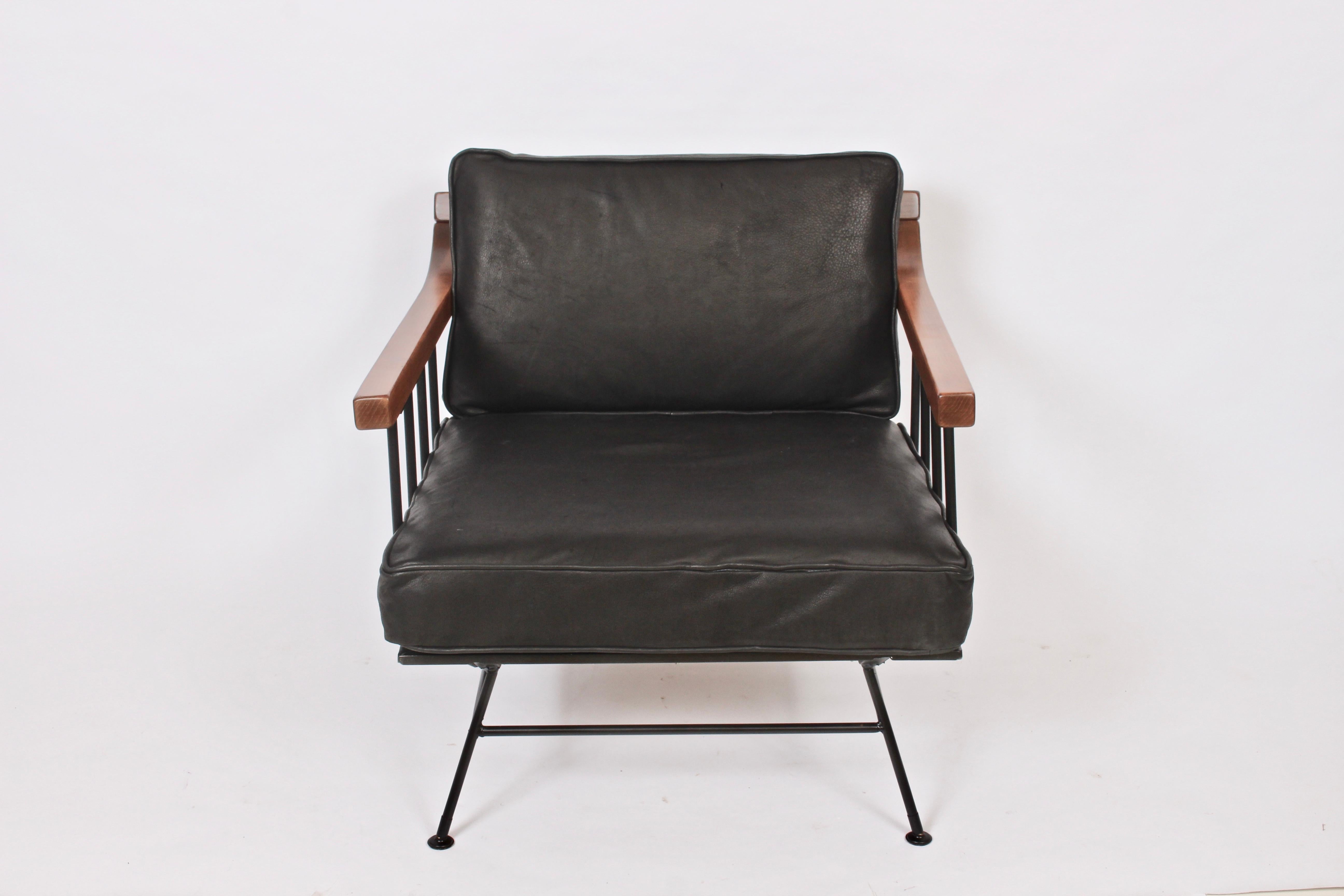 Richard McCarthy for Selrite lounge arm chair, 1950s. Featuring a Wrought Iron and Elm framework, contoured Elm armrests, newly upholstered distressed Black Leather removable and reversible cushions, spring and burlap center support, splayed Iron