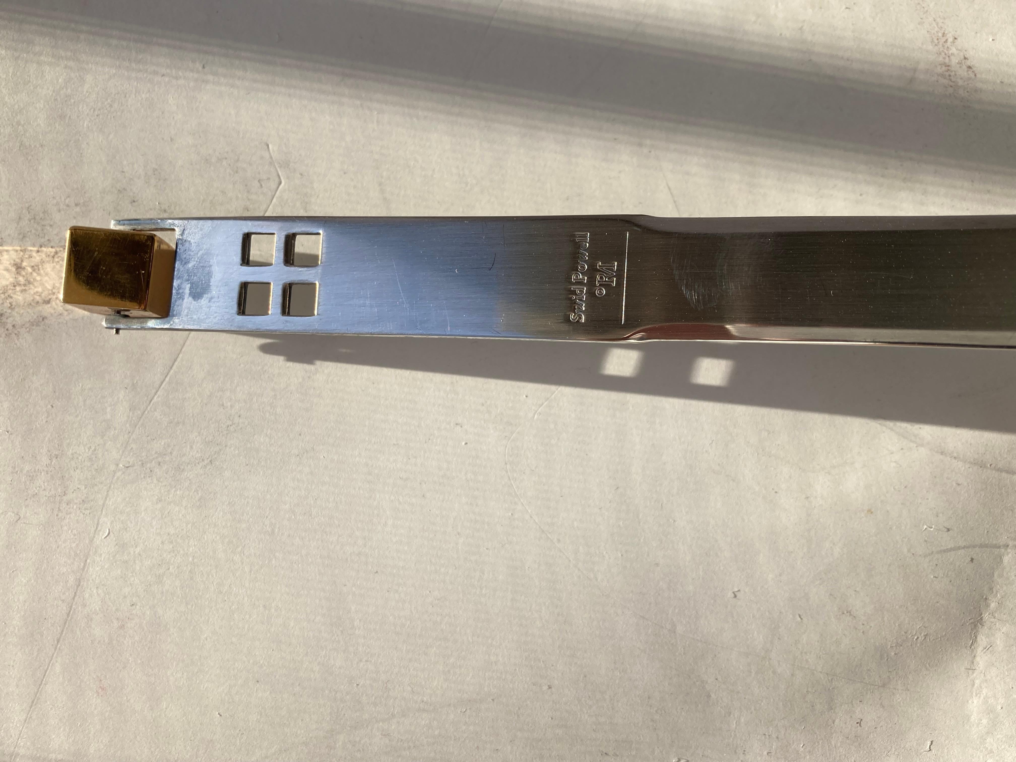 Great Post Modern design in this letter opener, by Richard Meier. The cube gold tone in back spins nicely and is a whimsical detail.