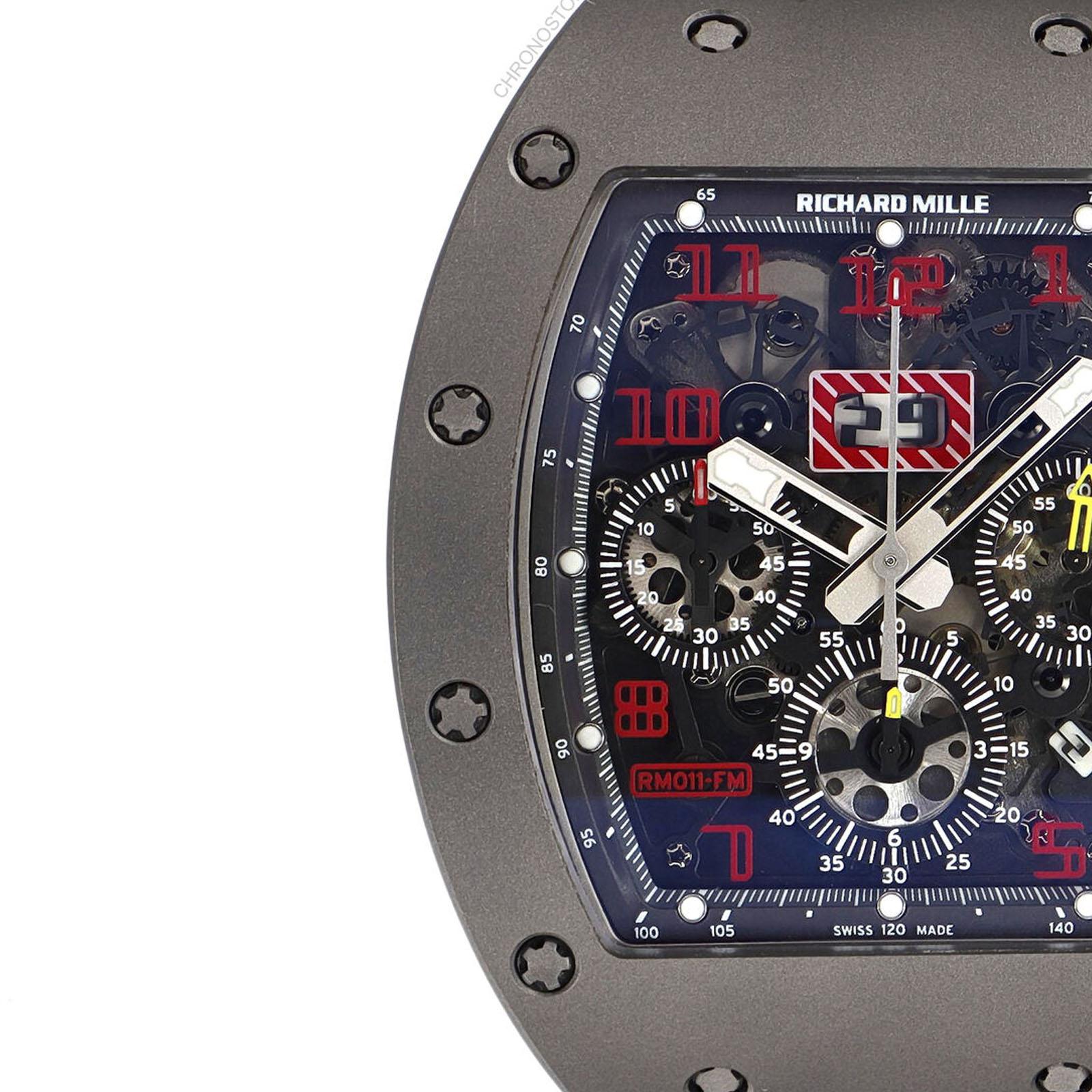 This pre-owned Richard Mille Felipe Massa RM011 is a beautiful men's timepiece that is powered by an automatic movement which is cased in a titanium case. It has a tonneau shape face, chronograph, date, small seconds subdial, tachymeter dial and has