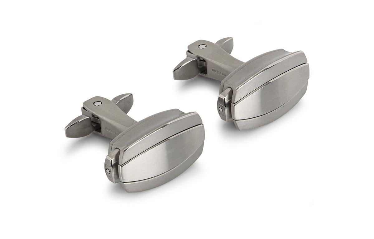 A pair of cufflinks by Richard Mille. The cufflinks are made from grade 5 titanium and have a satin brushed finish, complemented by a hand bevelled edge. The cufflinks feature a patented mechanism that opens the bars using push buttons on either