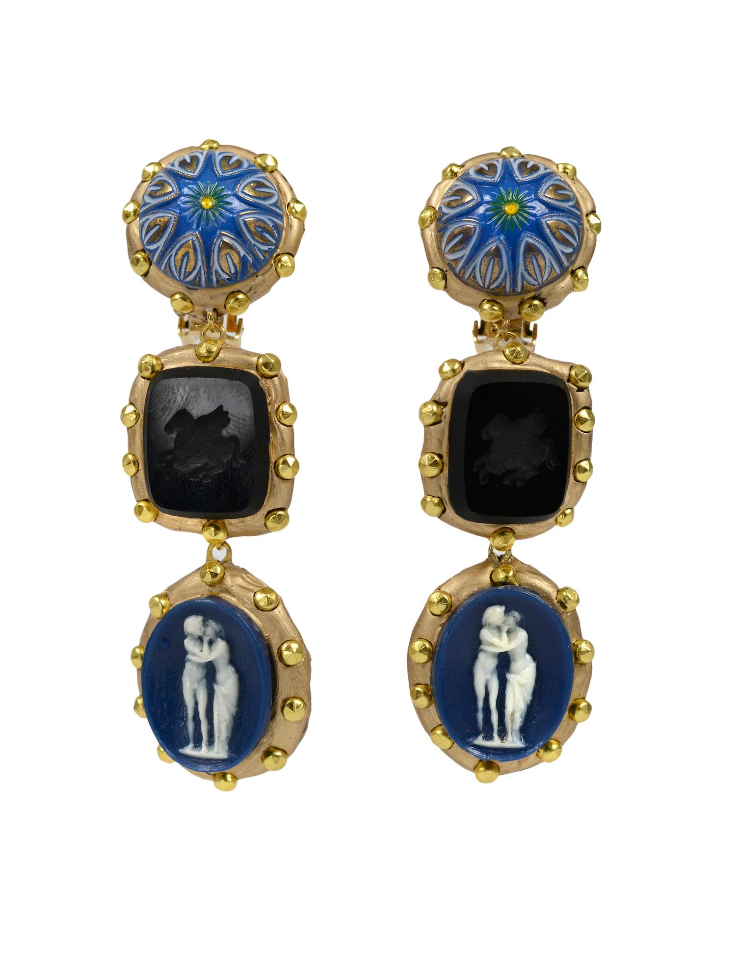 Handmade one-of-a-kind Richard Minadeo blue enamel and cameo drop clip earrings that feature vintage black and blue cameo charms set in gold resin with studs.

We are pleased to announce Resurrected: Richard Minadeo and the art of Memento Mori: