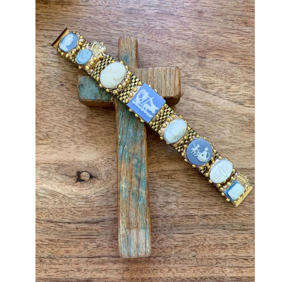 Richard Minadeo brass link bracelet featuring blue and white Wedgwood style cameos inset in gold-tone resin with gold studs.

Famous in the ’80s for his handmade, one of a kind, and extremely personal jewelry and mementos, Richard Minadeo is most