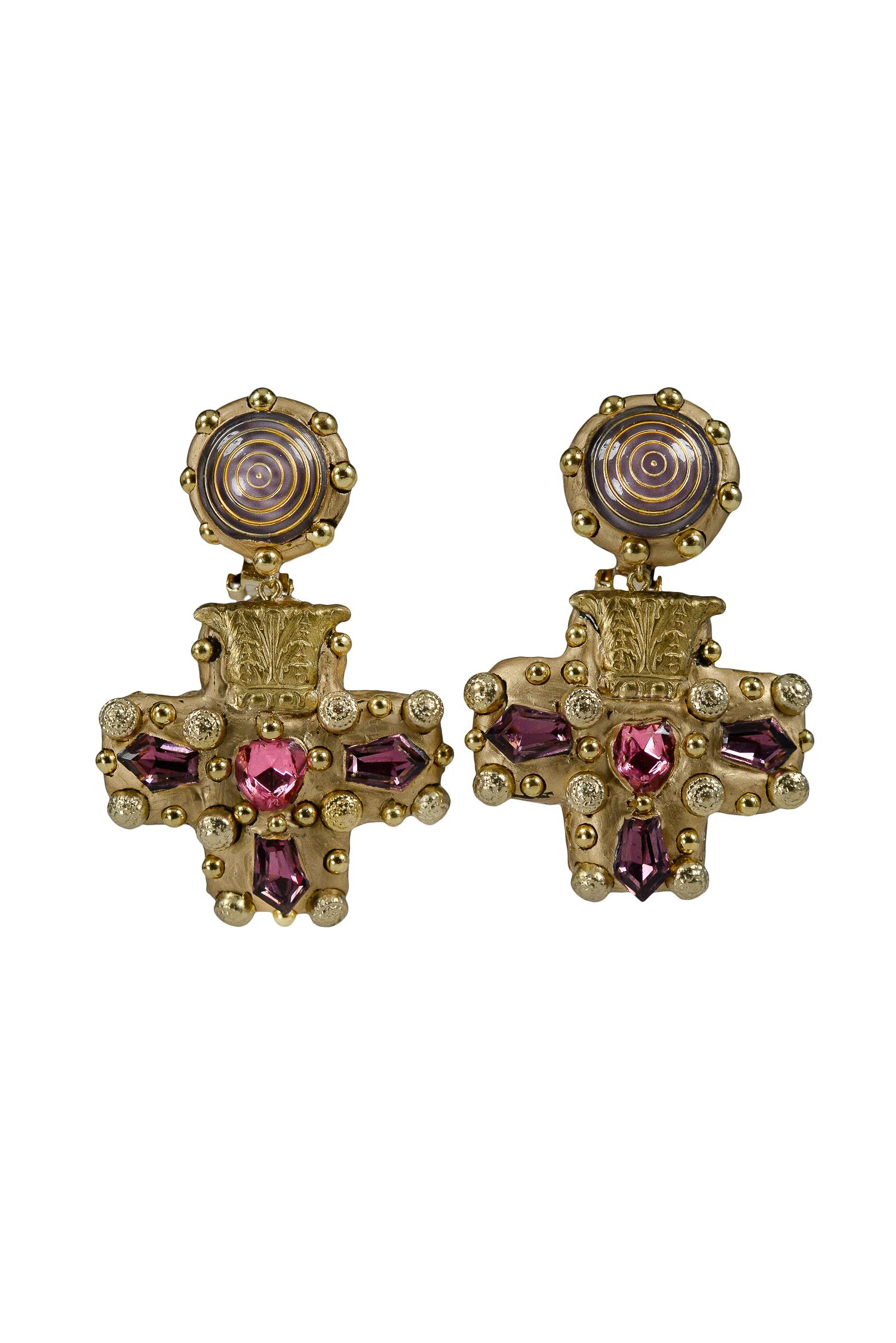 Handmade and one-of-a-kind- Richard Minadeo purple and pink gemstone cross earrings with glass purple and gold swirl set in gold-tone resin with gold studs.

We are pleased to announce Resurrected: Richard Minadeo and the art of Memento Mori: 1980’s
