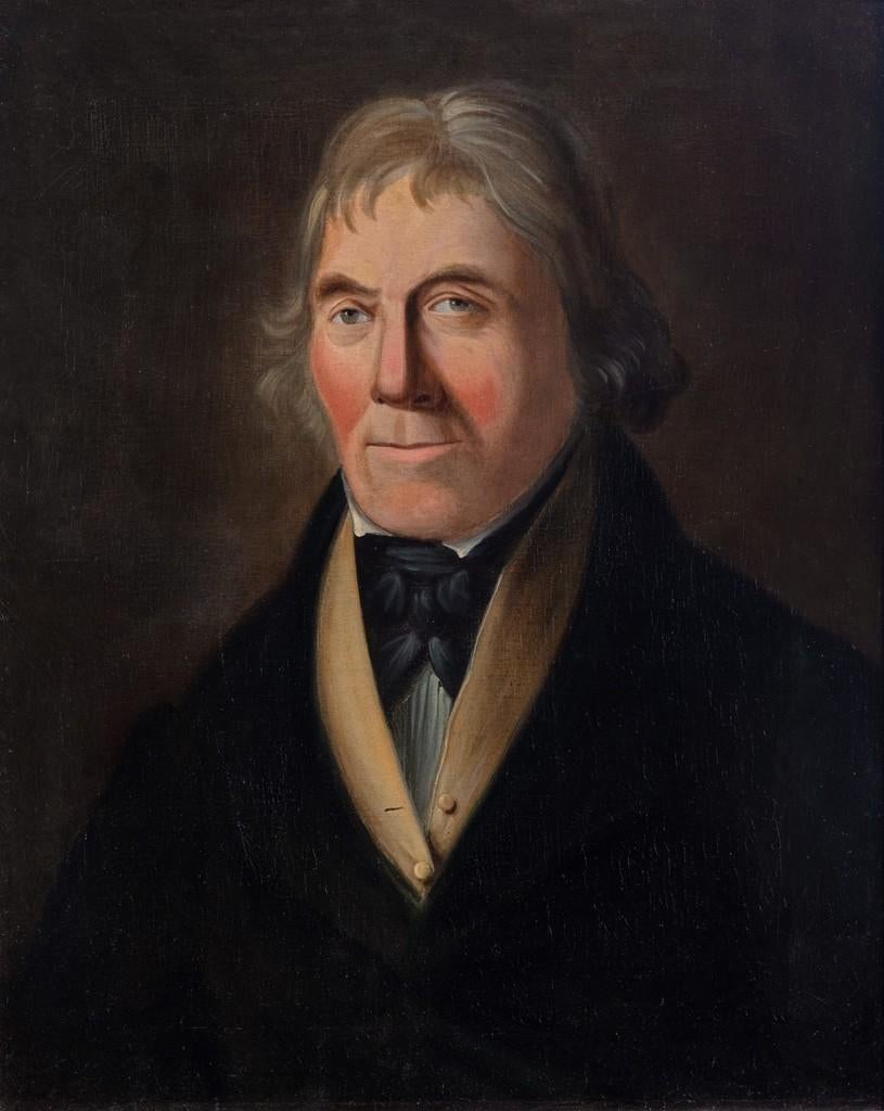 This head and shoulders portrait shows a man with a black cravat and top coat with a buttoned camel colored waistcoat and white shirt below, oil on canvas, inscribed on the back ‘Robert [sic] Nicholson of Blyth , Chief Carpenter, aboard H.M.S.