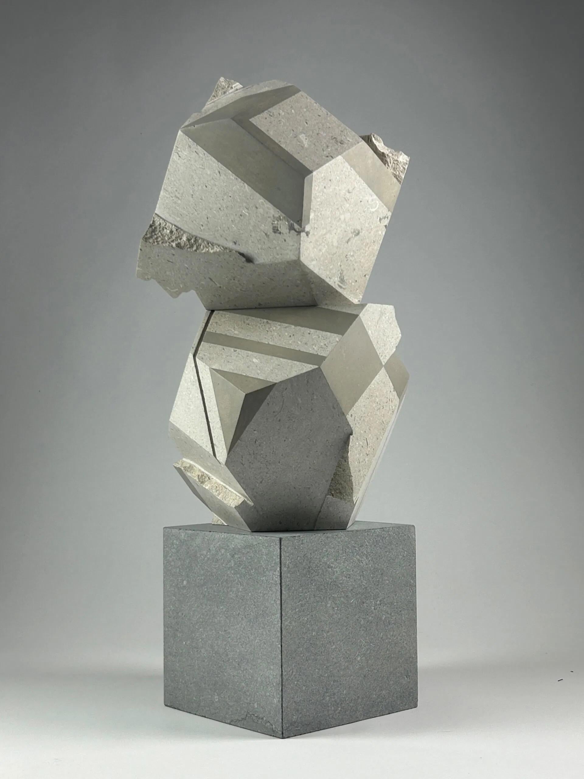 Three Stacks is a sculpture by the English artist, Richard Perry. This sculpture is made up of three stacked geometric forms, each precisely uniquely oriented, creating a sense of motion and instability. The soft gray-beige tones and the contrast