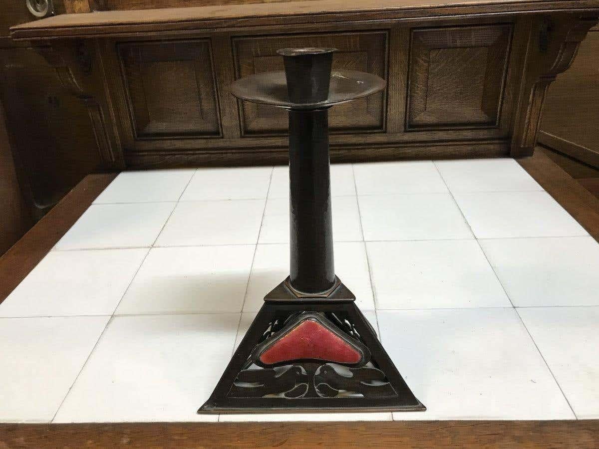 Richard Llewellyn Benson Rathbone. Attributed to C.F.A. Voysey
An English Arts & Crafts large copper candlestick with red enamel heart and tree decoration and kissing love doves to the triangular base.
Beautiful original chocolate patina to the