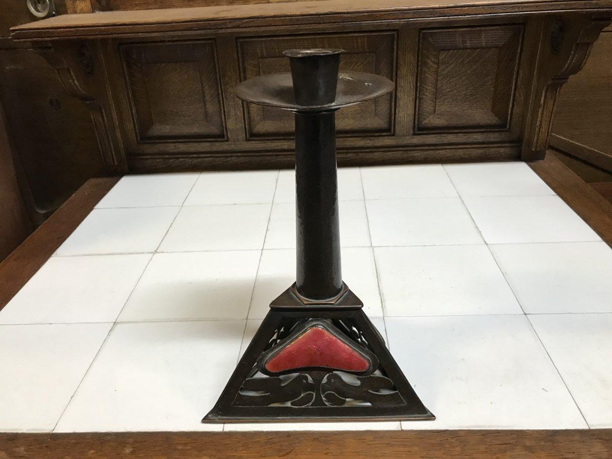 By Richard Llewellyn Benson Rathbone in the style of C. F. A. Voysey.
Hand-hammered pewter candlestick triangular base with rich red enamel Love Hearts to the three sides and twin kissing doves in the copper work design.
With beautiful original