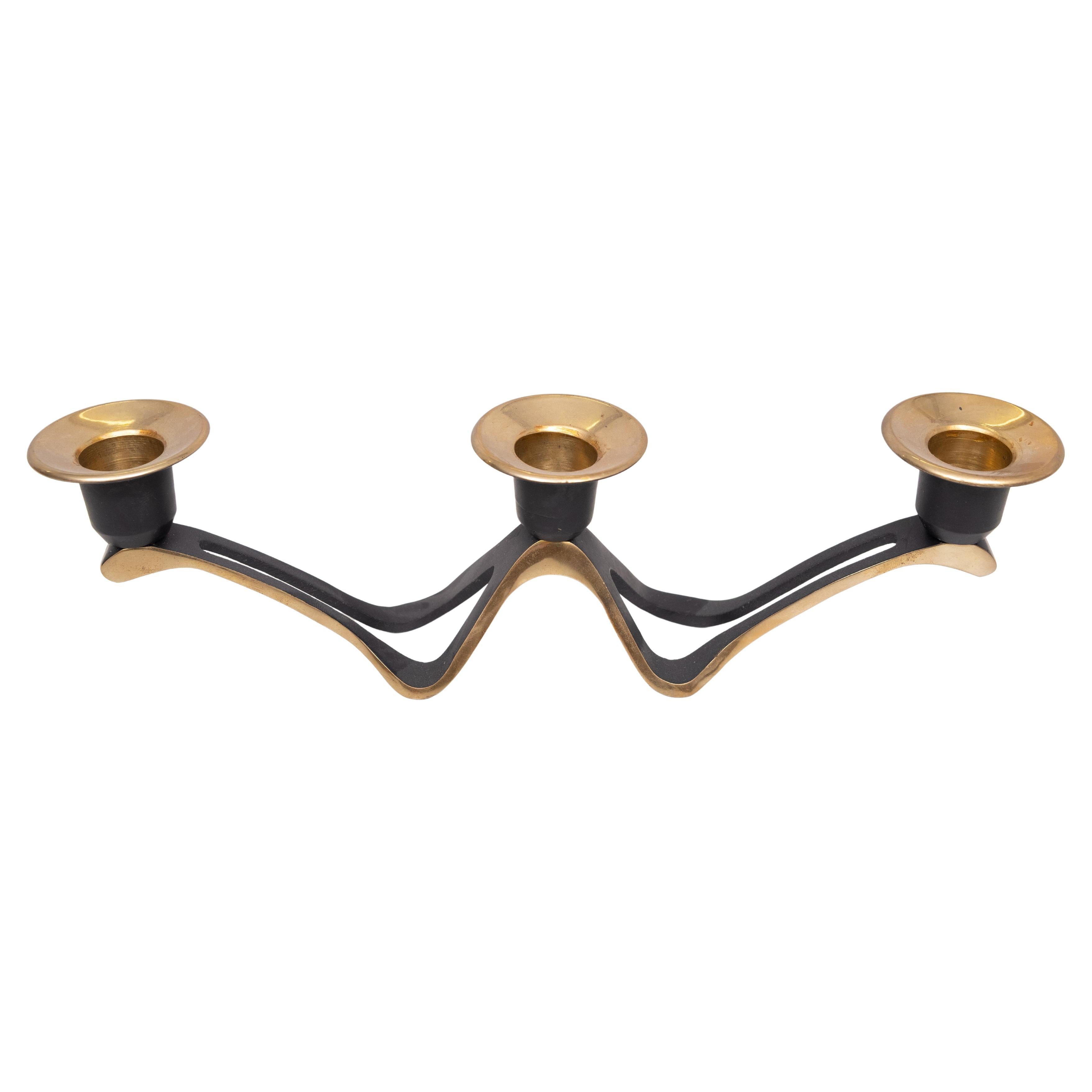 Table Candle Holder with 3 lights, made of
heavy iron and brass in a typical
Mid Century Modern triangle shape and
the base frame formed into a 