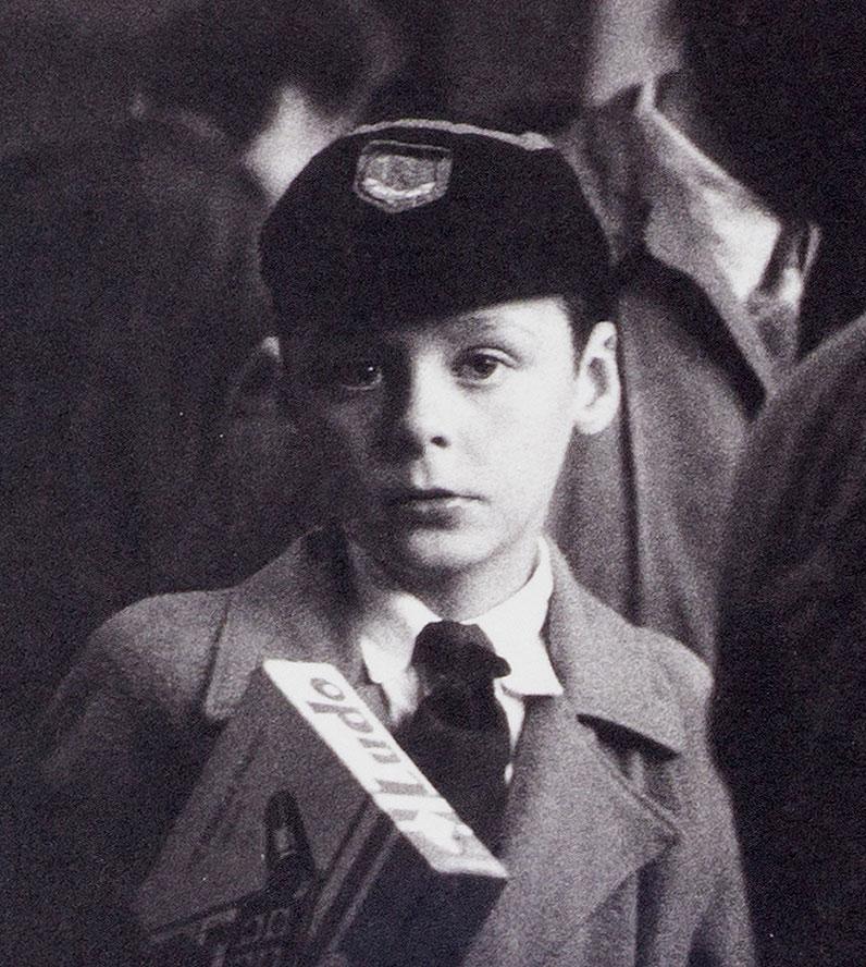 Young Lad ( haunting portrait of young boy on a crowded London street) - Photograph by Richard Sadler