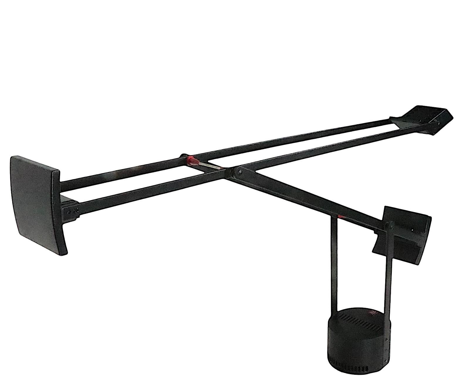 Iconic Post Modern angle poise desk lamp, made in Italy, designed by Richard Sapper for Artimide circa 1970's.
 The lamp features a flex arm composted of  two elements ( Lower 20 in. x Upper 29 in. ) which are attached to a cylindrical plinth base.