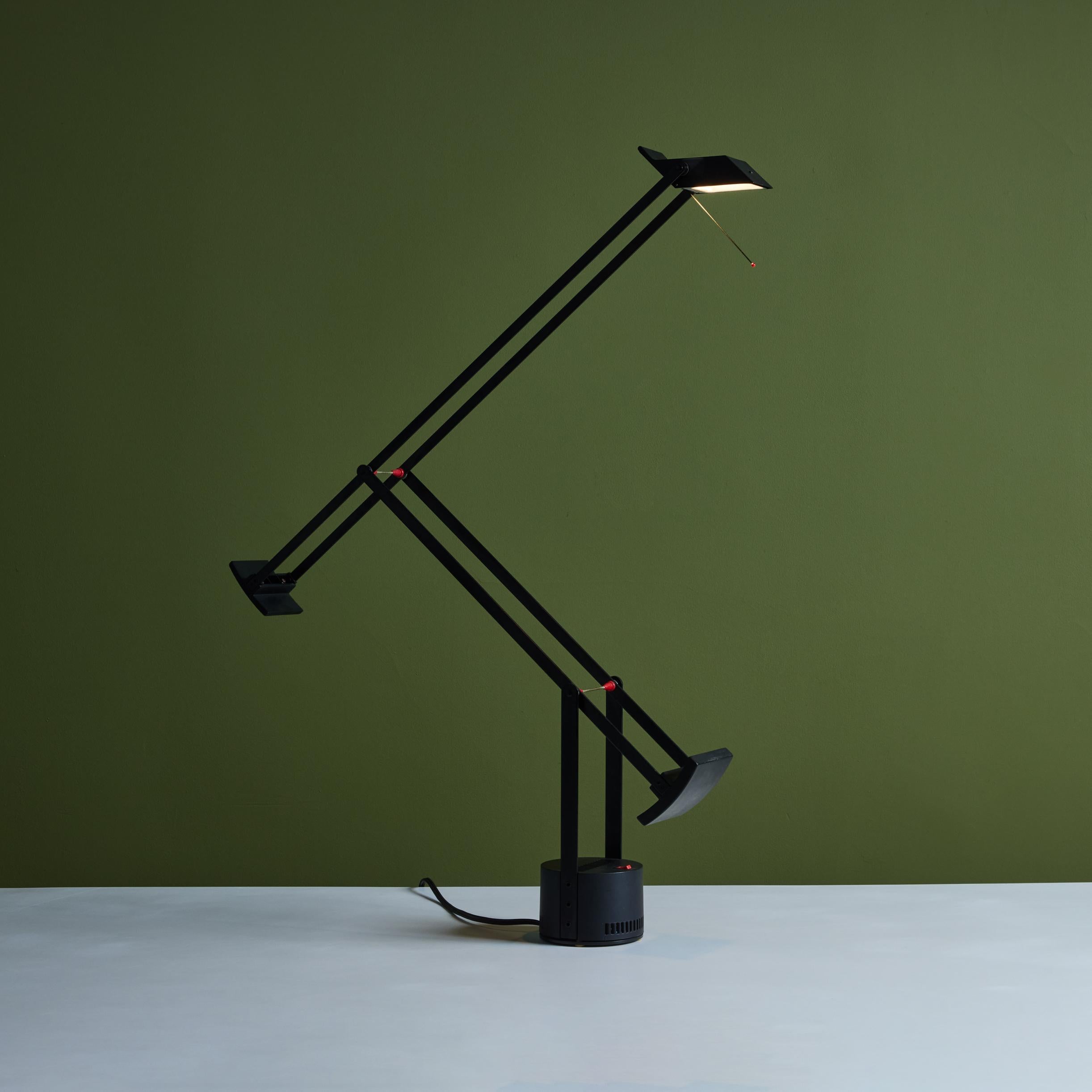 “Tizio” desk lamp by Richard Sapper for Artemide, c.1970s, Italy. The lamp features a black enameled metal base and stem with counterweights to push and pull the lamp to its desired position and the ability to swivel. The lamp showcases a red on/off