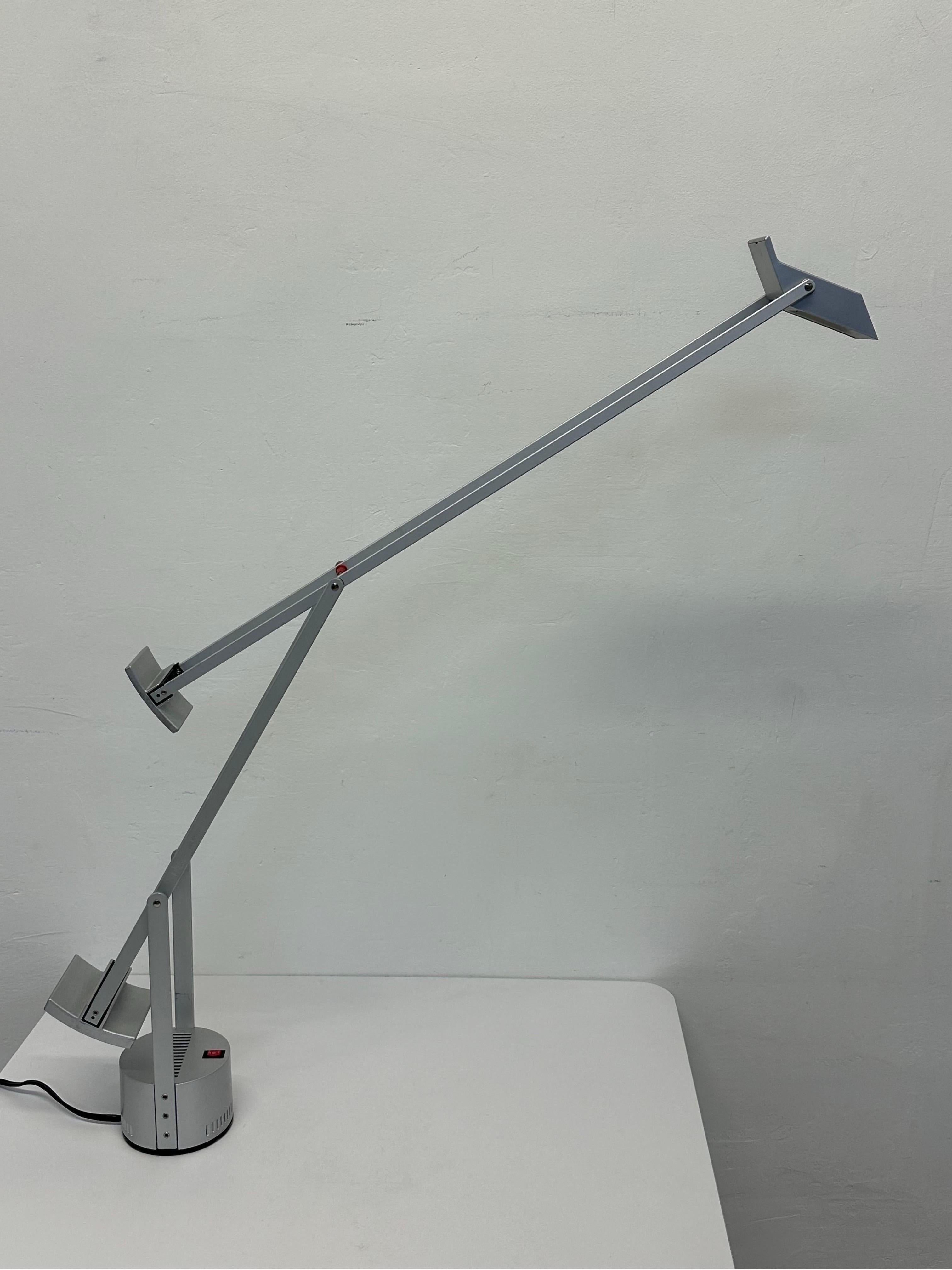 Rare, signed Tizio table or desk lamp from the first production run of silver and red color scheme.  Only 3000 lamps were produced and the lamp is numbered 1043.  Fully adjustable and lamps have high/low toggle for desired brightness.