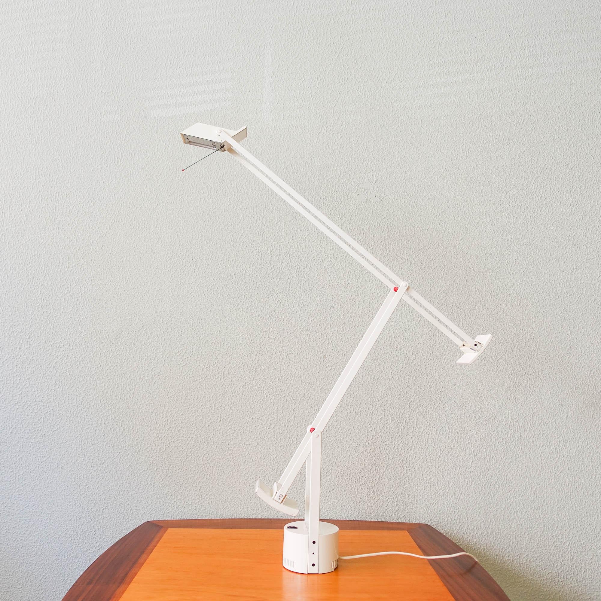 Cette lampe de table, modèle Tizio, a été conçue par Richard Sapper pour Artemide, en Italie, en 1972. Présentée en 1972, la lampe est construite avec deux contrepoids permettant à l'utilisateur de diriger la lumière à sa guise.
La lampe s'ajuste