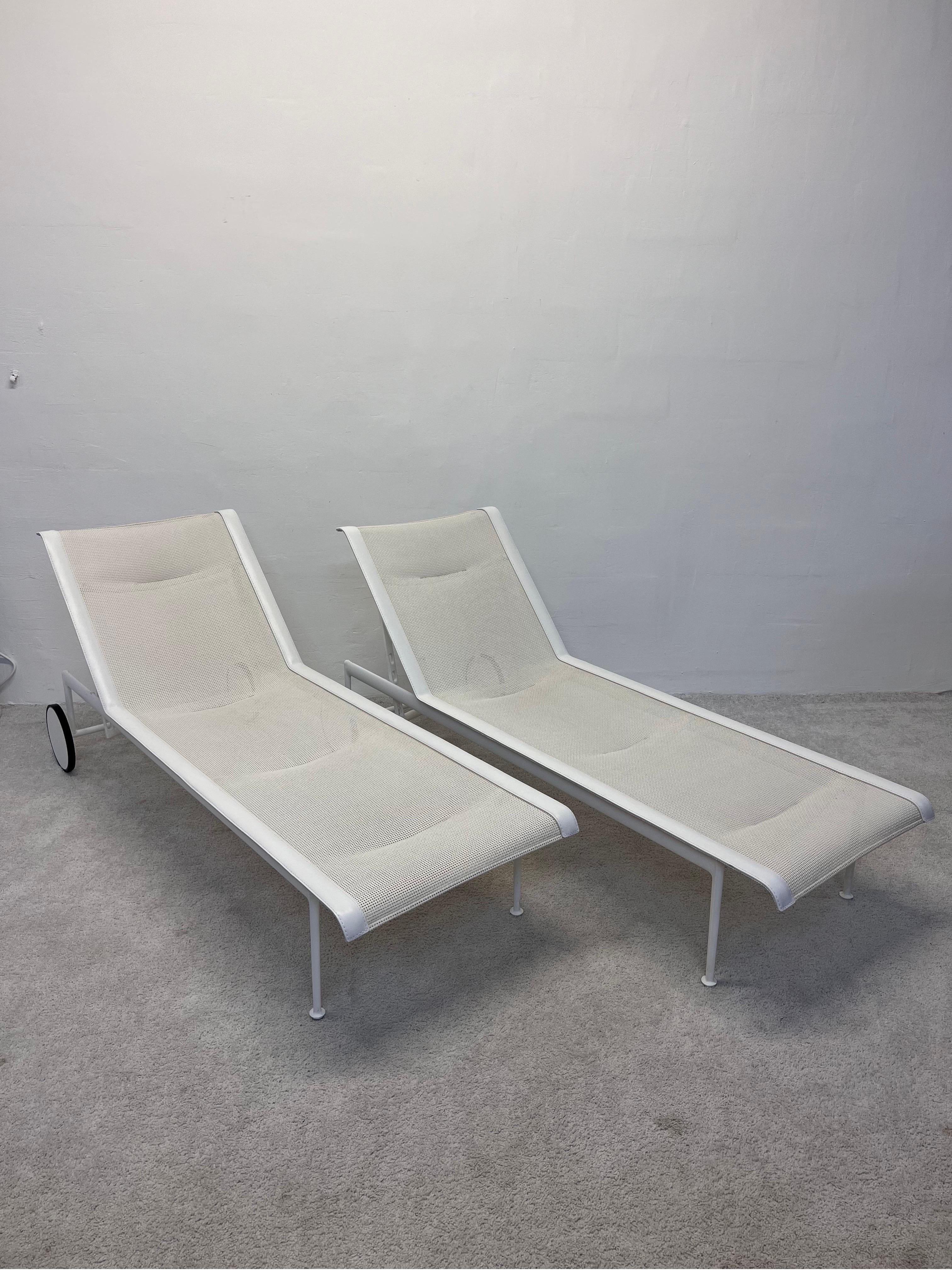 Pair of adjustable 1966 chaise lounges with vinyl mesh fabric and white vinyl stitched edge on a white powder coated aluminum frame originally designed by Richard Schultz for Knoll. These were produced circa early 2000s.