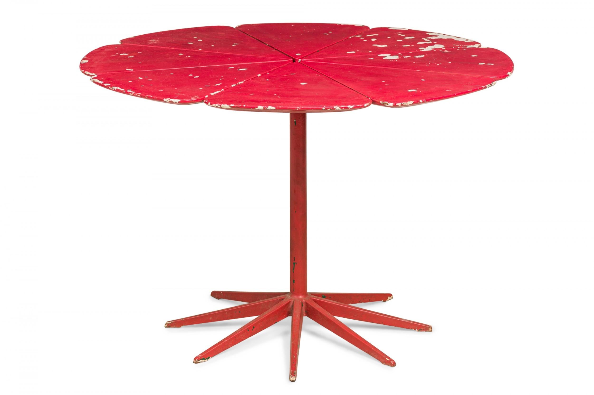 American Mid-Century 'petal' form center table made of redwood and finished with red lacquer, resting on a pedestal base. (RICHARD SCHULTZ FOR KNOLL INTERNATIONAL).
 